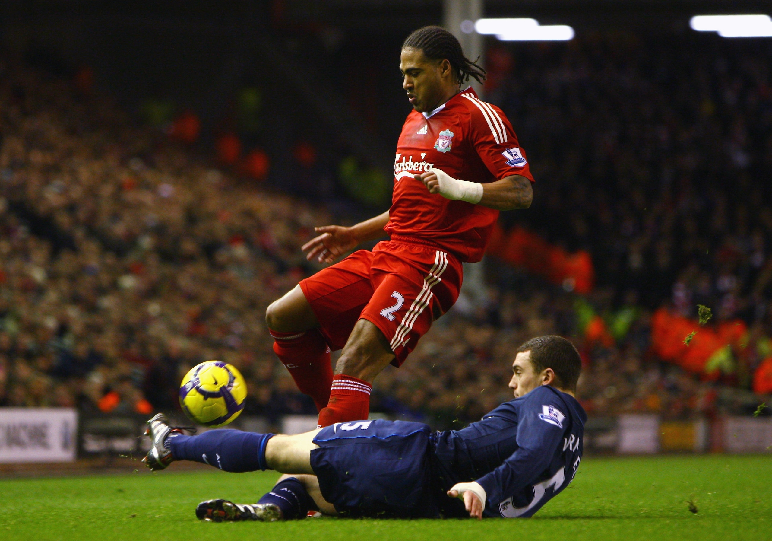 LIVERPOOL, ENGLAND - DECEMBER 13:  Thomas Vermaelen of Arsenal tackles Glen Johnson of Liverpool during the Barclays Premier League match between Liverpool and Arsenal at Anfield on December 13, 2009 in Liverpool, England. (Photo by Clive Brunskill/Getty