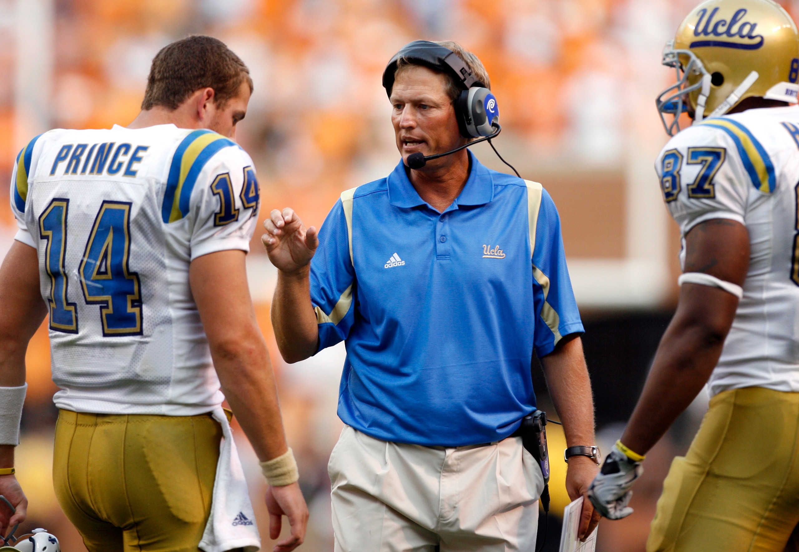KNOXVILLE, TN - SEPTEMBER 12: Rick Neuheisel, head coach of the UCLA Bruins talks with Kevin Prince #14 of the UCLA Bruins during a timeout against the Tennessee Volunteers on September 12, 2009 at Neyland Stadium in Knoxville, Tennessee. The Bruins beat 