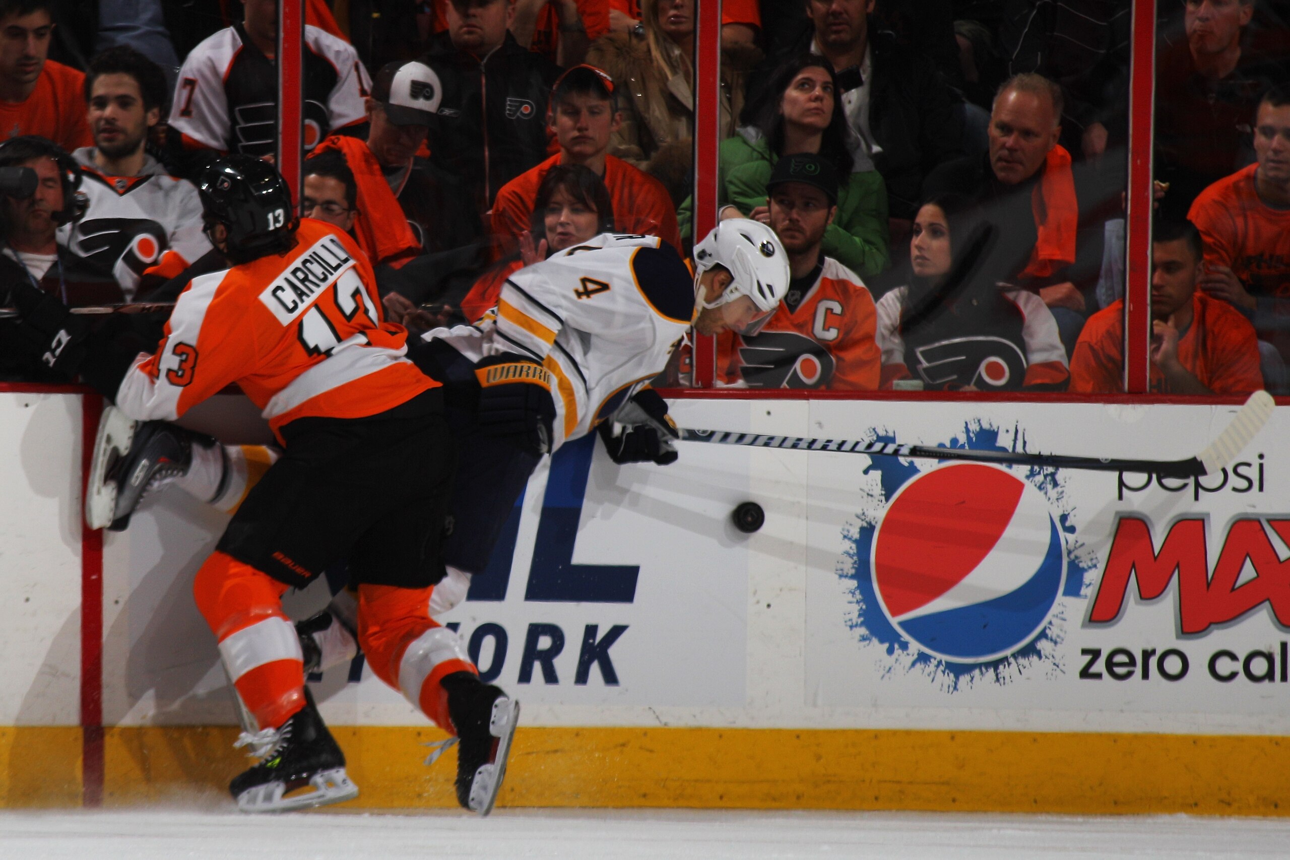 PHILADELPHIA, PA - APRIL 22: Daniel Carcillo #13 of the Philadelphia Flyers checks Steve Montador #4 of the Buffalo Sabres in Game Five of the Eastern Conference Quarterfinals during the 2011 NHL Stanley Cup Playoffs at Wells Fargo Center on April 22, 20 PHILADELPHIA, PA - APRIL 22: Daniel Carcillo #13 of the Philadelphia Flyers checks Steve Montador #4 of the Buffalo Sabres in Game Five of the Eastern Conference Quarterfinals during the 2011 NHL Stanley Cup Playoffs at Wells Fargo Center on April 22, 20