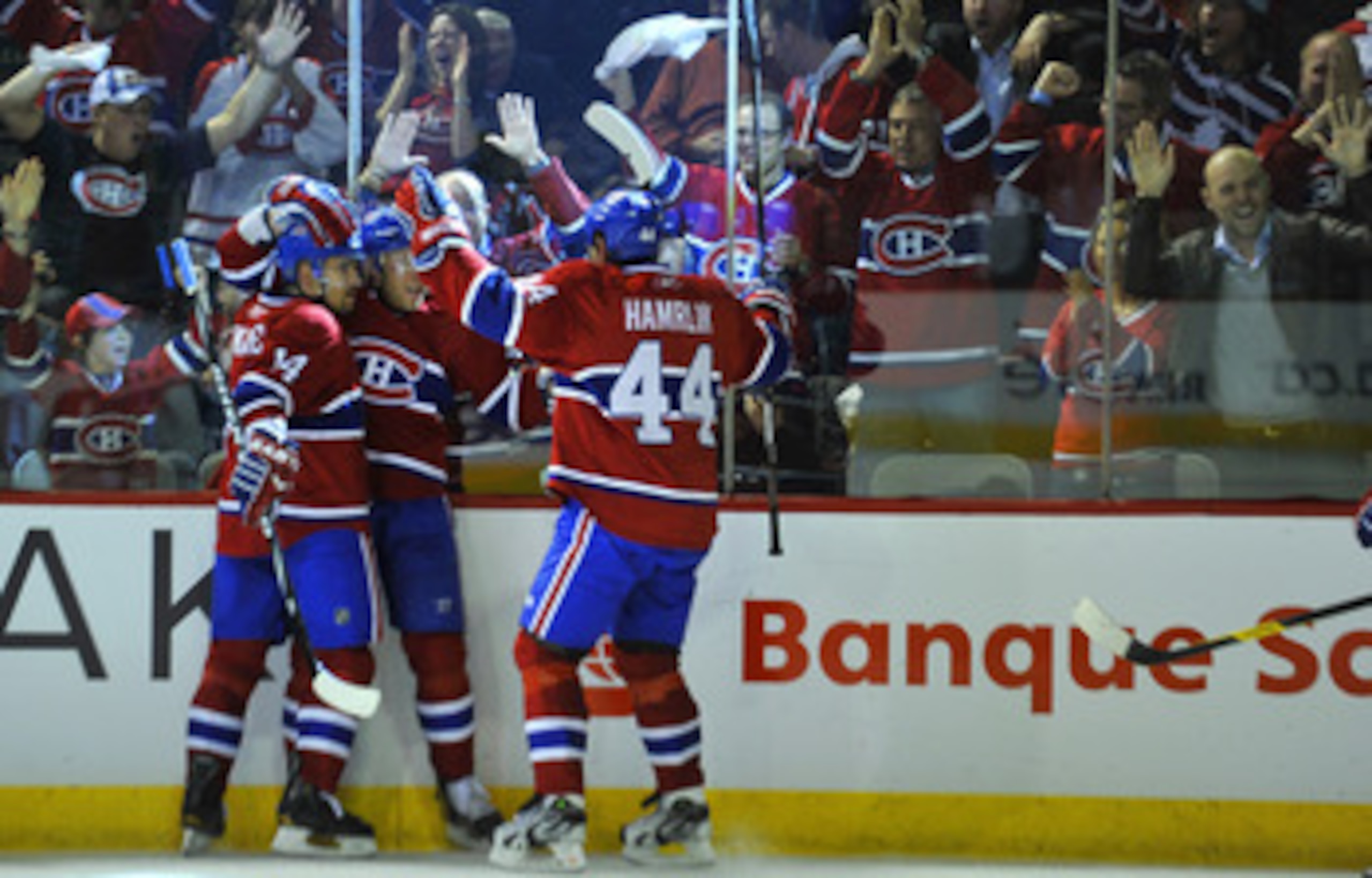 MONTREAL, CANADA - APRIL 18:  Tomas Plekanec #14; Andrei Kostitsyn #46 and Roman Hamrlik #44 of the Montreal Canadiens celebrate a goal against the Boston Bruins in Game Three of the Eastern Conference Quarterfinals during the 2011 NHL Stanley Cup Playoff