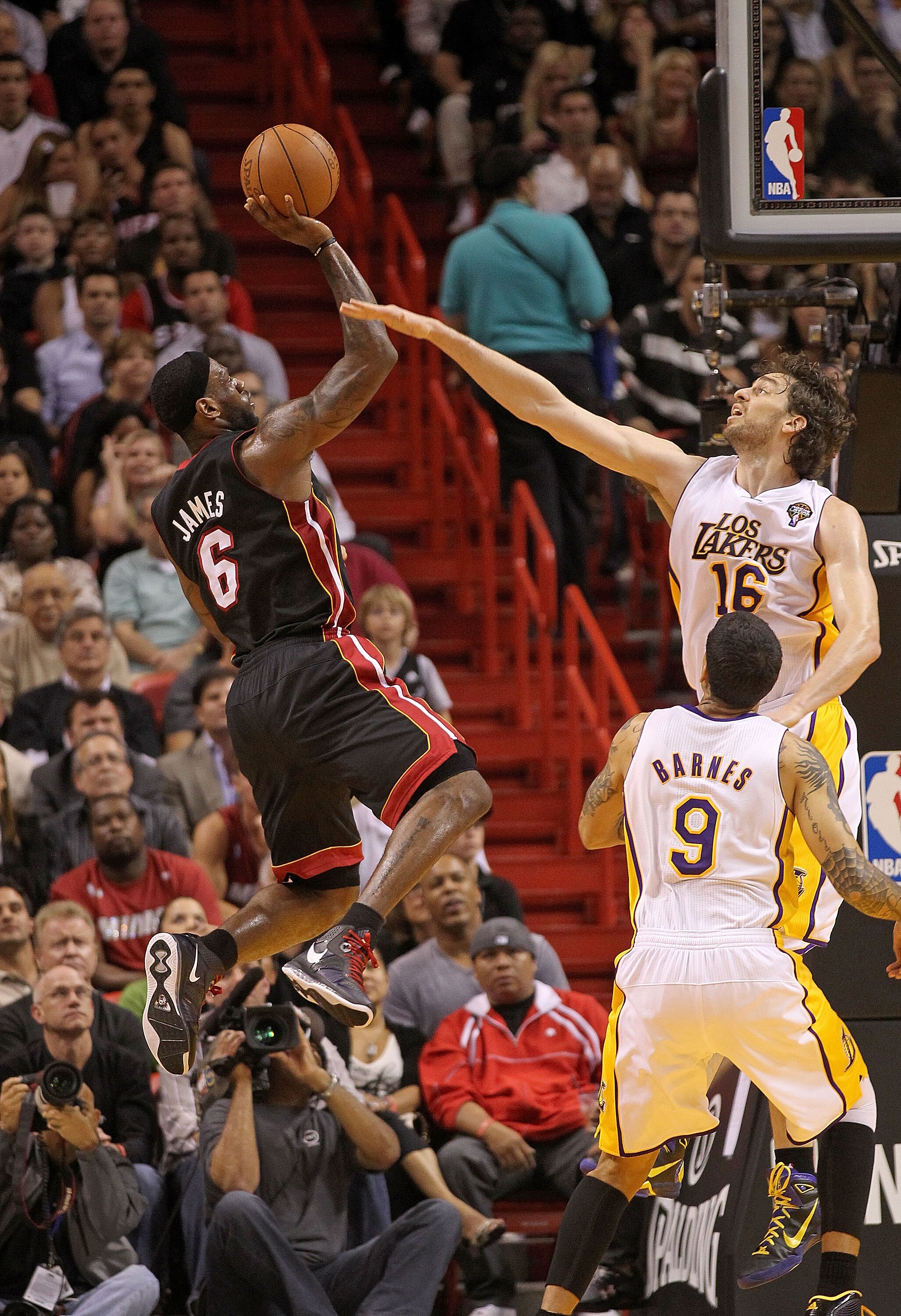 MIAMI, FL - MARCH 10:  LeBron James #6 of the Miami Heat shoots over Pau Gasol #16 of  the Los Angeles Lakers  during a game at American Airlines Arena on March 10, 2011 in Miami, Florida. NOTE TO USER: User expressly acknowledges and agrees that, by down