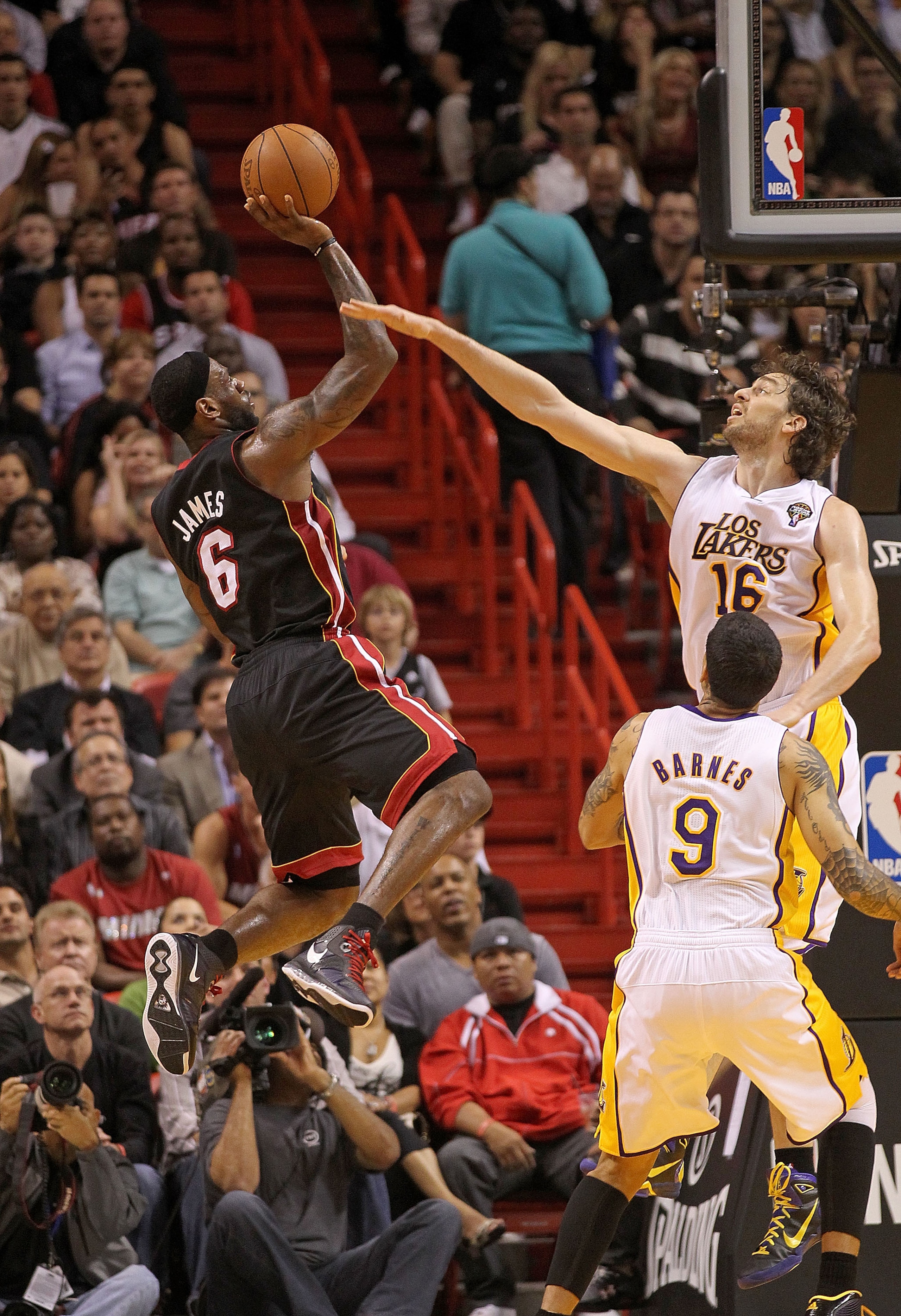 MIAMI, FL - MARCH 10:  LeBron James #6 of the Miami Heat shoots over Pau Gasol #16 of  the Los Angeles Lakers  during a game at American Airlines Arena on March 10, 2011 in Miami, Florida. NOTE TO USER: User expressly acknowledges and agrees that, by down