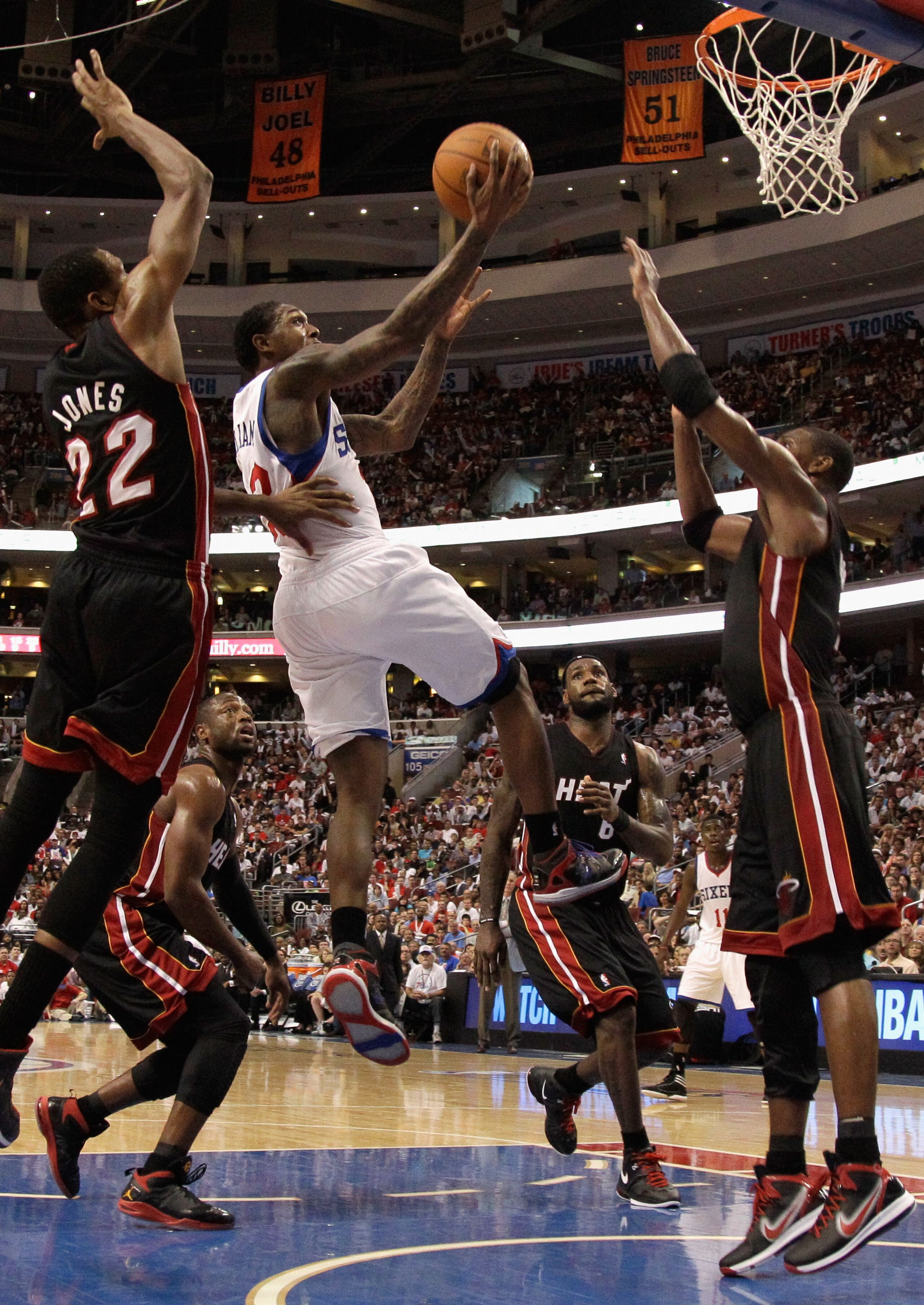 PHILADELPHIA, PA - APRIL 24:  Lou Williams #23 of the Philadelphia 76ers (C) puts up a shot while being defended by James Jones #22 and Chris Bosh #1 of the Miami Heat during the second half in Game Four of the Eastern Conference Quarterfinals in the 2011