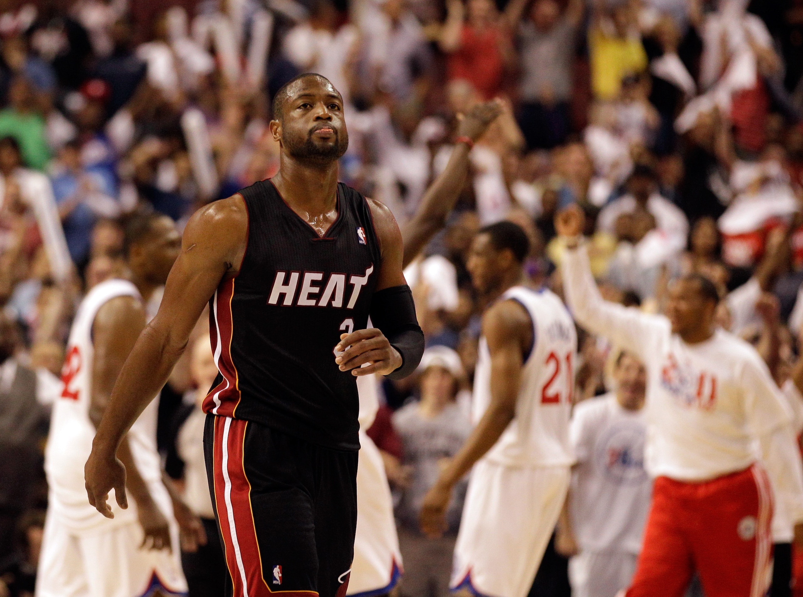 PHILADELPHIA, PA - APRIL 24: Dwyane Wade #3 of the Miami Heat walks off the court as members of the Philadelphia 76ers celebrate their 86-82 win in Game Four of the Eastern Conference Quarterfinals in the 2011 NBA Playoffs at Wells Fargo Center on April 2
