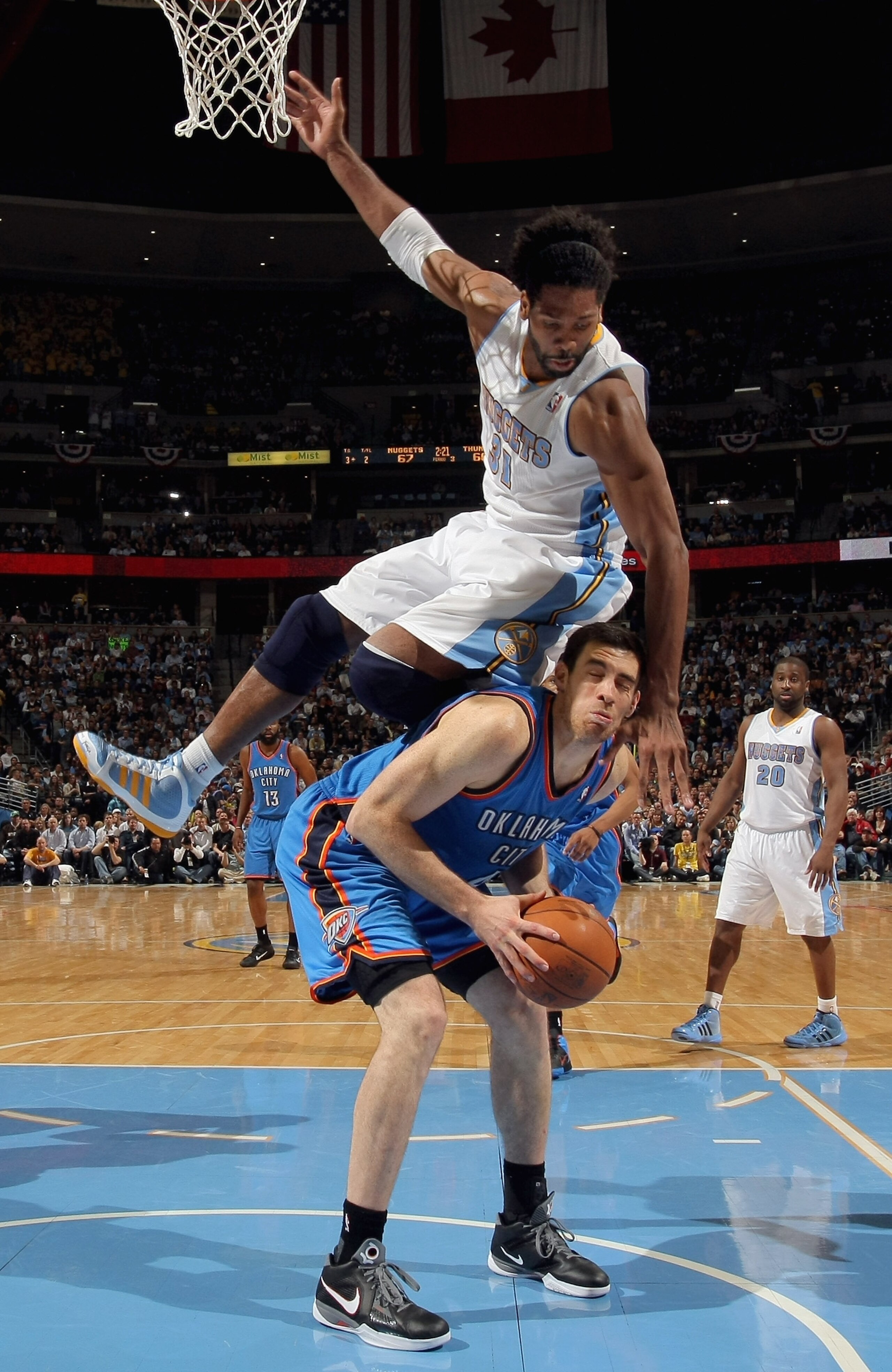 DENVER, CO - APRIL 25:  Nick Collison #4 of the Oklahoma City Thunder tries to get off a shot but is fouled by Nene Hilario #31 of the Denver Nuggets in Game Four of the Western Conference Quarterfinals in the 2011 NBA Playoffs on April 24, 2011 at the Pe