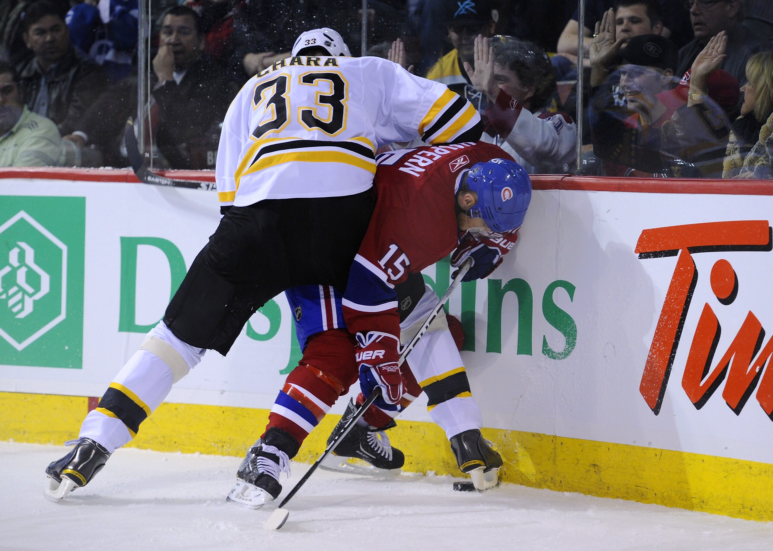MONTREAL, CANADA - APRIL 21: Zdeno Chara #33 of the Boston Bruins pins Jeff Halpern #15 of the Montreal Canadiens to the end boards in Game Four of the Eastern Conference Quarterfinals during the 2011 NHL Stanley Cup Playoffs at the Bell Centre on April MONTREAL, CANADA - APRIL 21: Zdeno Chara #33 of the Boston Bruins pins Jeff Halpern #15 of the Montreal Canadiens to the end boards in Game Four of the Eastern Conference Quarterfinals during the 2011 NHL Stanley Cup Playoffs at the Bell Centre on April