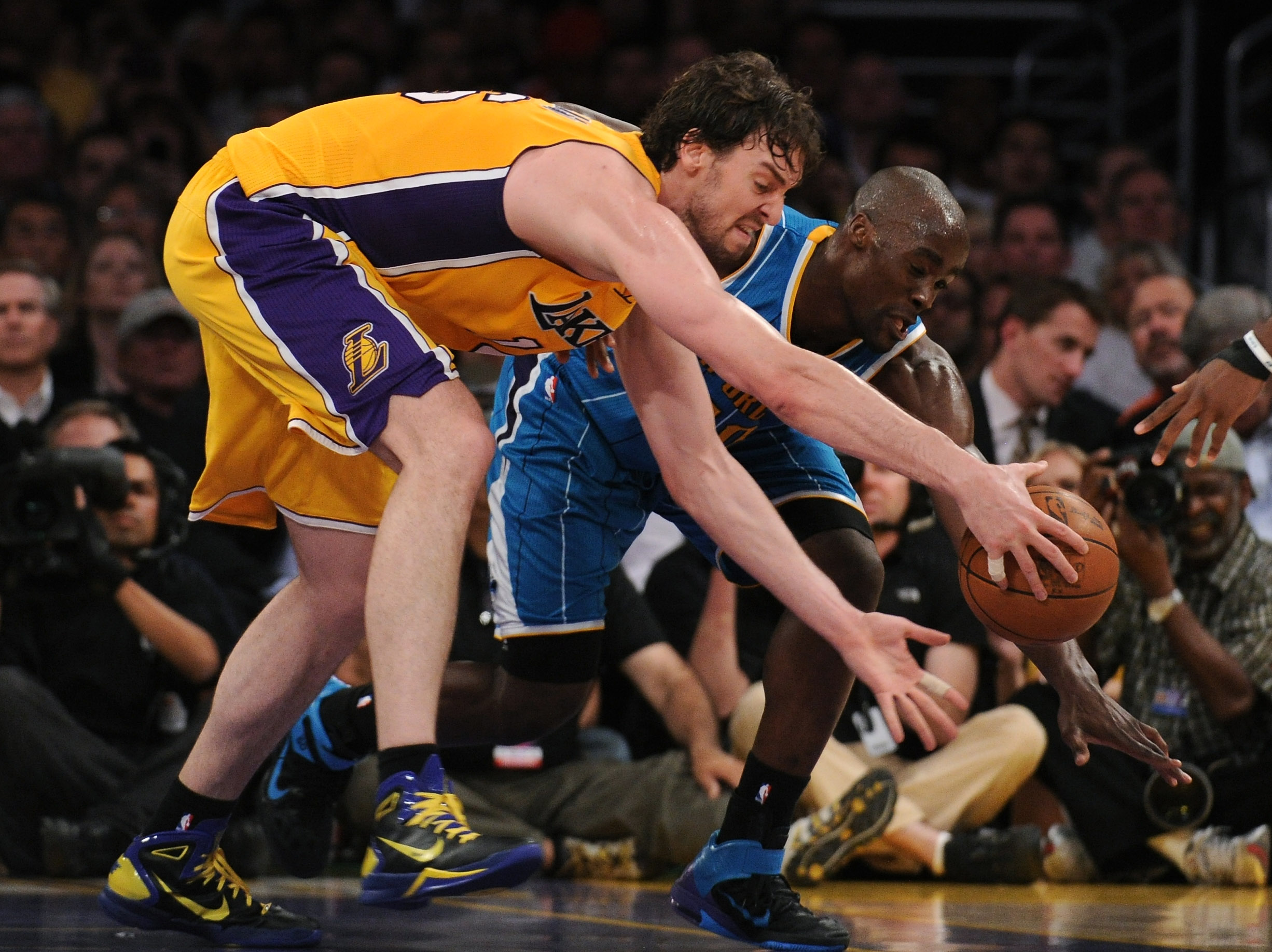 LOS ANGELES, CA - APRIL 26:  Pau Gasol #16 of the Los Angeles Lakers and Emeka Okafor #50 of the New Orleans Hornets battle for a loose ball in the third quarter in Game Five of the Western Conference Quarterfinals in the 2011 NBA Playoffs on April 26, 20
