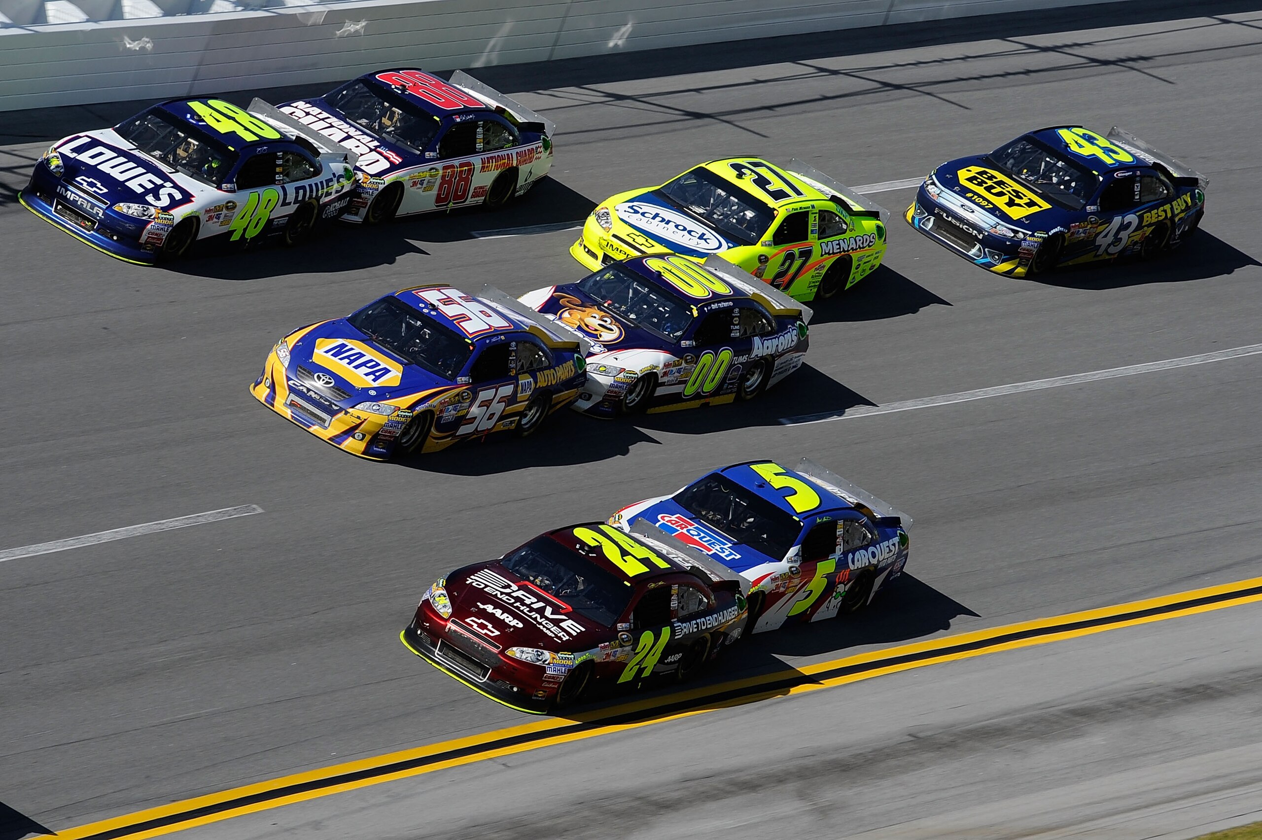 TALLADEGA, AL - APRIL 17:  Jimmie Johnson, driver of the #48 Lowe's Chevrolet, Martin Truex Jr., driver of the #56 NAPA Toyota, and Jeff Gordon, driver of the #24 Drive To End Hunger/AARP Chevrolet, lead the field during the NASCAR Sprint Cup Series Aaron