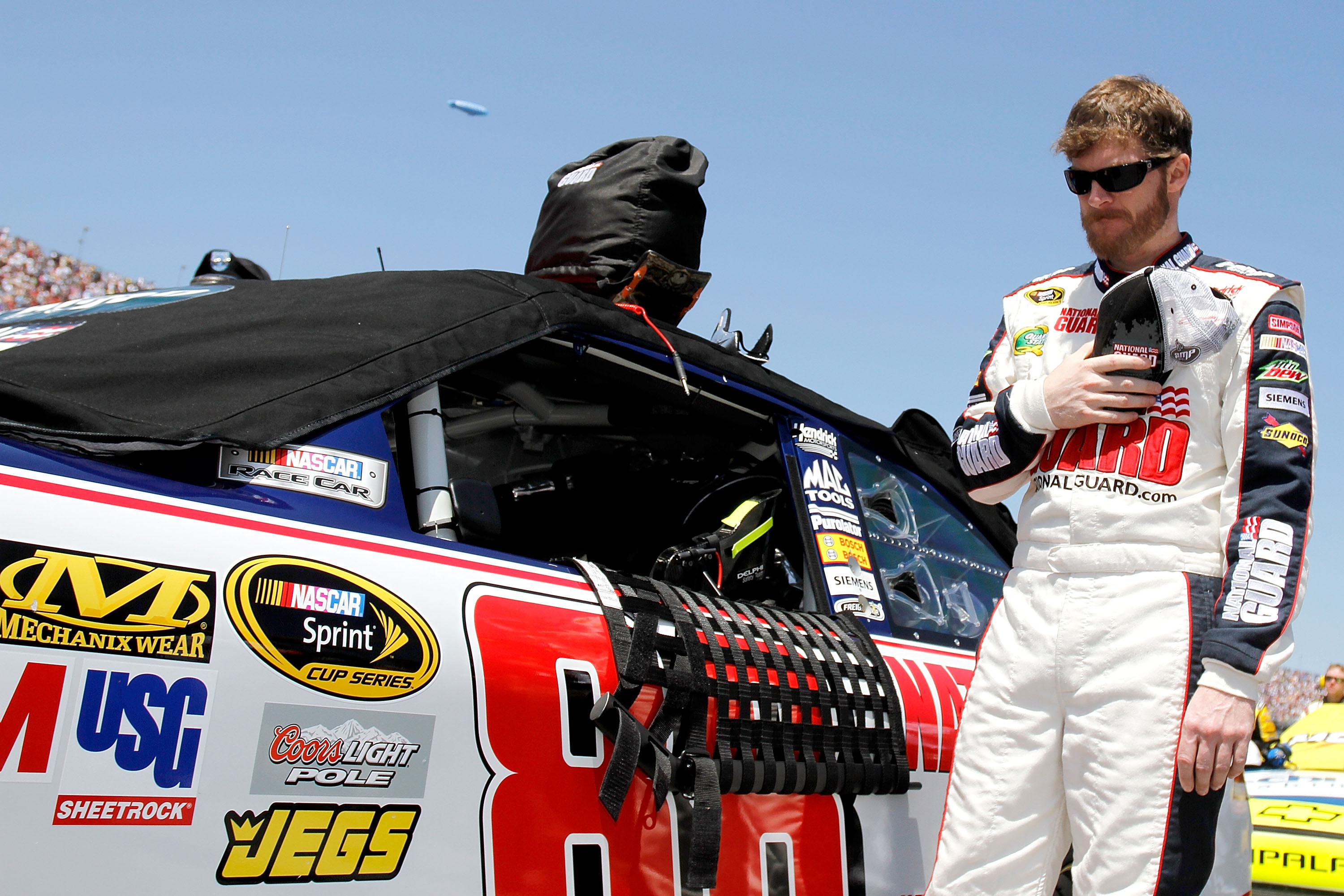 TALLADEGA, AL - APRIL 17:  Dale Earnhardt Jr., driver of the #88 National Guard/Amp Energy Chevrolet, stands on the grid prior to the start of the NASCAR Sprint Cup Series Aaron's 499 at Talladega Superspeedway on April 17, 2011 in Talladega, Alabama.  (P