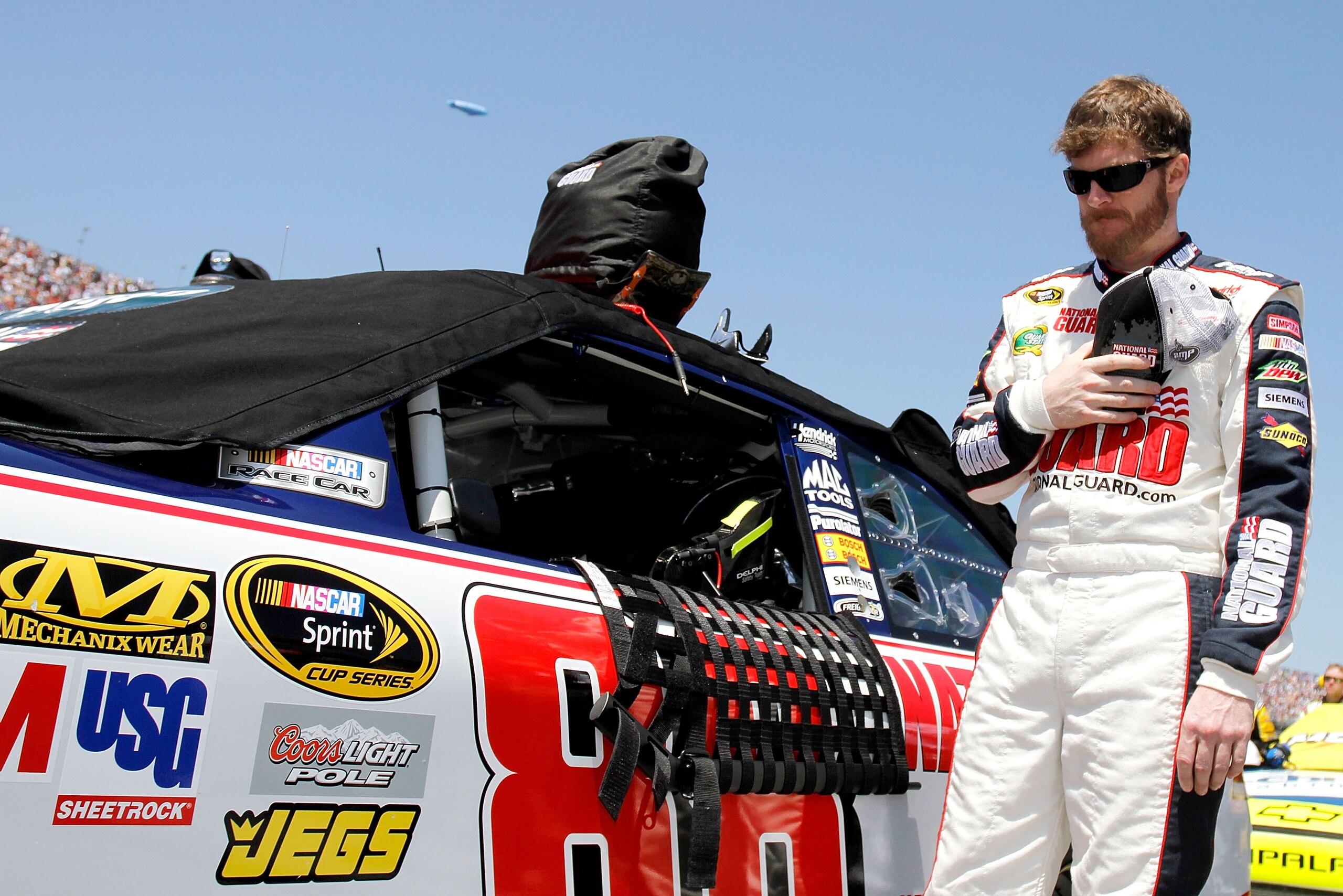 TALLADEGA, AL - APRIL 17:  Dale Earnhardt Jr., driver of the #88 National Guard/Amp Energy Chevrolet, stands on the grid prior to the start of the NASCAR Sprint Cup Series Aaron's 499 at Talladega Superspeedway on April 17, 2011 in Talladega, Alabama.  (P