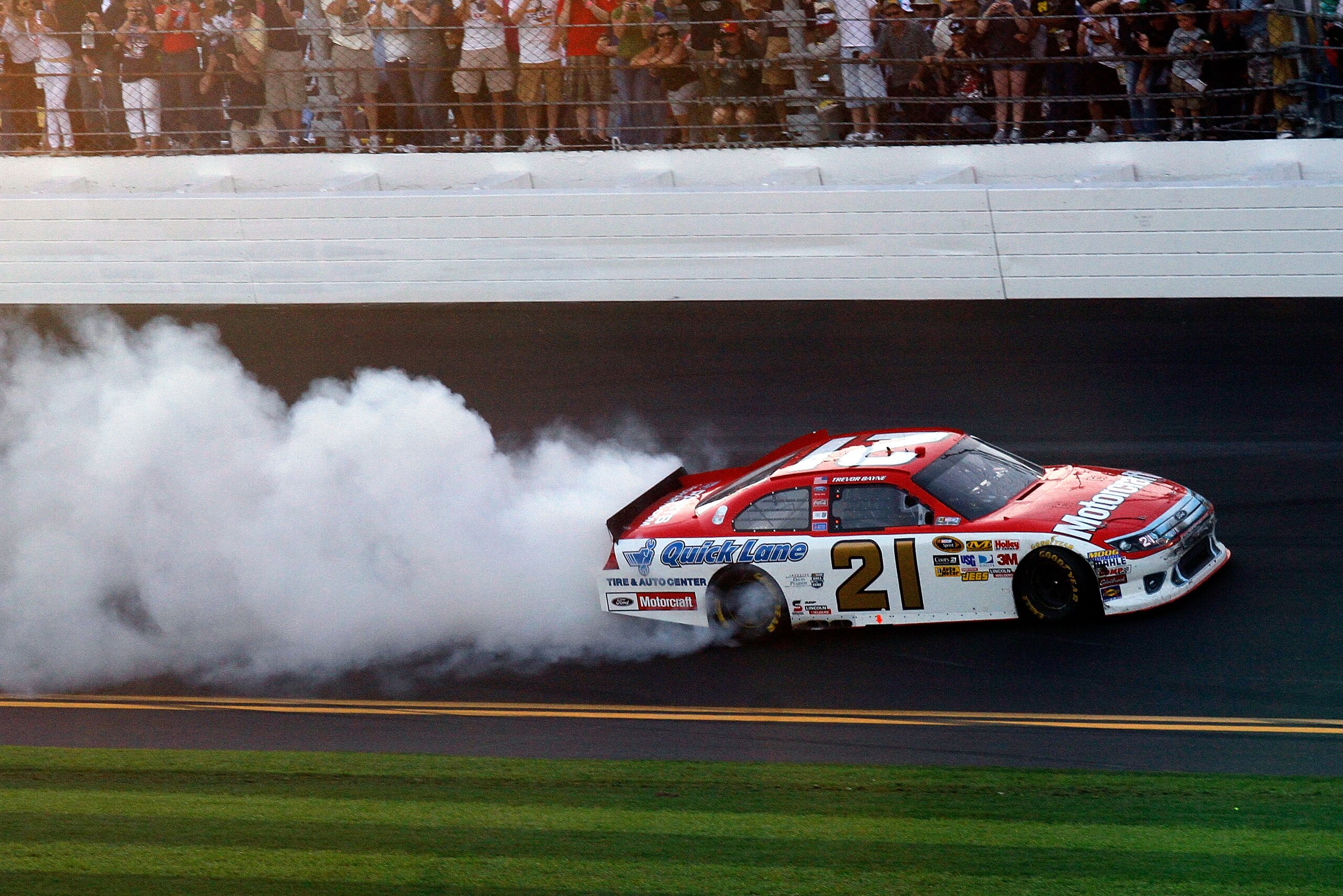 DAYTONA BEACH, FL - FEBRUARY 20:  Trevor Bayne, driver of the #21 Motorcraft/Quick Lane Ford, celebrates with a burnout after winning the NASCAR Sprint Cup Series Daytona 500 at Daytona International Speedway on February 20, 2011 in Daytona Beach, Florida