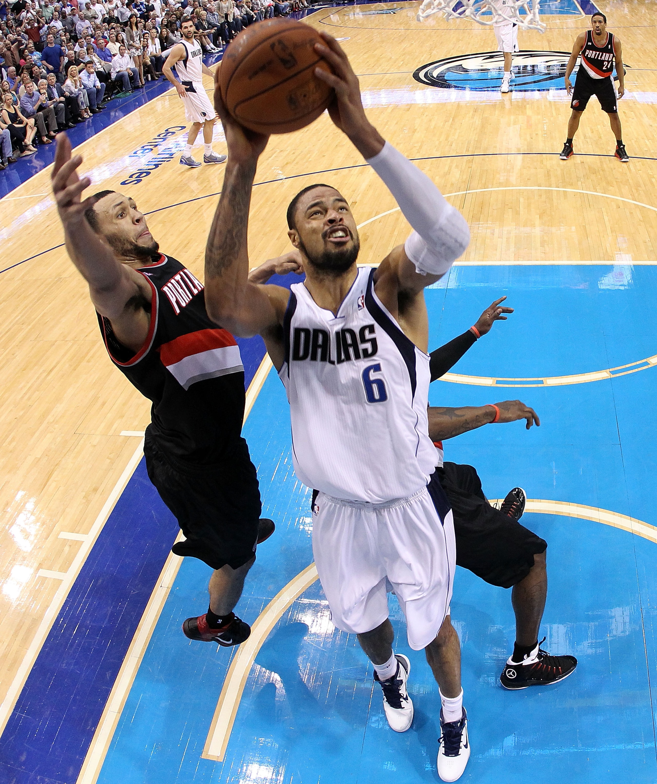 DALLAS, TX - APRIL 25:  Center Tyson Chandler #6 of the Dallas Mavericks takes a shot against Brandon Roy #7 of the Portland Trail Blazers in Game Five of the Western Conference Quarterfinals during the 2011 NBA Playoffs on April 25, 2011 at American Airl