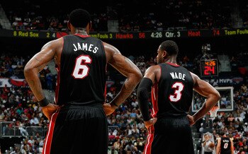 ATLANTA, GA - APRIL 11:  LeBron James #6 and Dwyane Wade #3 of the Miami Heat stand during a free throw against the Atlanta Hawks at Philips Arena on April 11, 2011 in Atlanta, Georgia.  NOTE TO USER: User expressly acknowledges and agrees that, by downlo