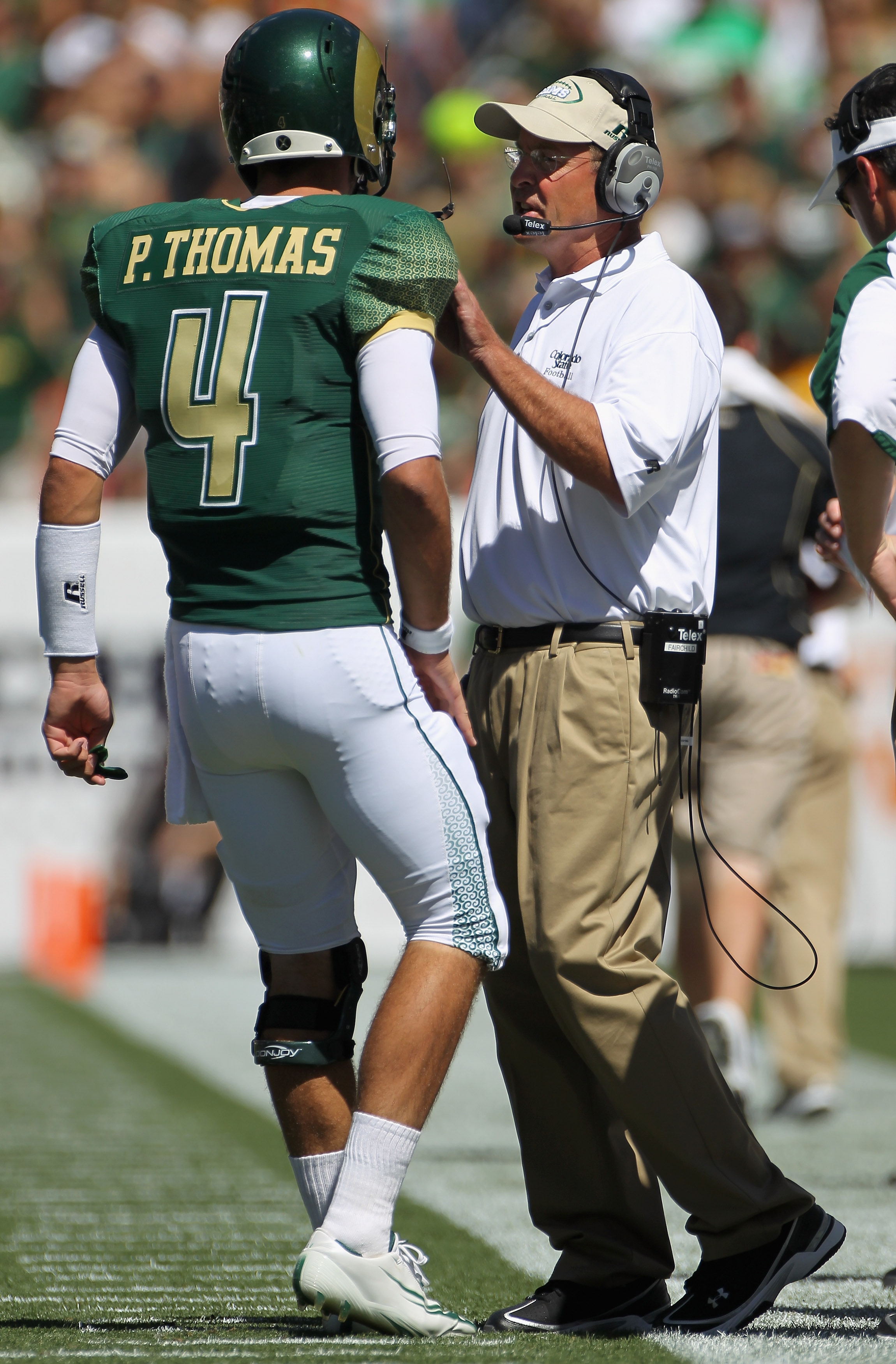 DENVER - SEPTEMBER 04:  Head coach Steve Fairchild of the Colorado State Rams talks to quarterback Pete Thomas #4 as they face the Colorado Buffaloes in the Rocky Mountain Showdown at INVESCO Field at Mile High on September 4, 2010 in Denver, Colorado. Co