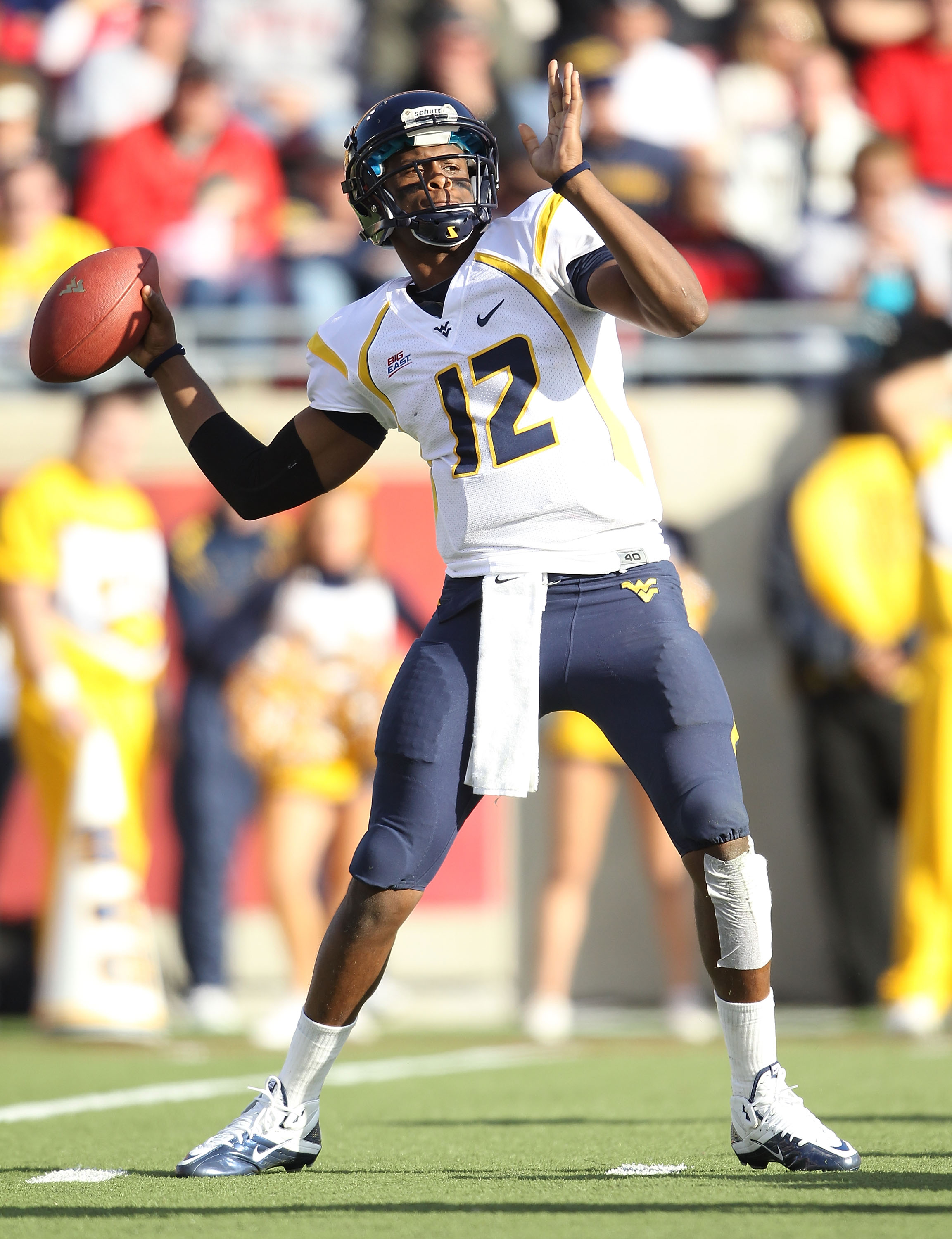 LOUISVILLE, KY - NOVEMBER 20: Geno Smith#12 of the West Virginia Mountaineers throws a pass during the Big East Conference game against the Louisville Cardinals at Papa John's Cardinal Stadium on November 20, 2010 in Louisville, Kentucky.  (Photo by Andy
