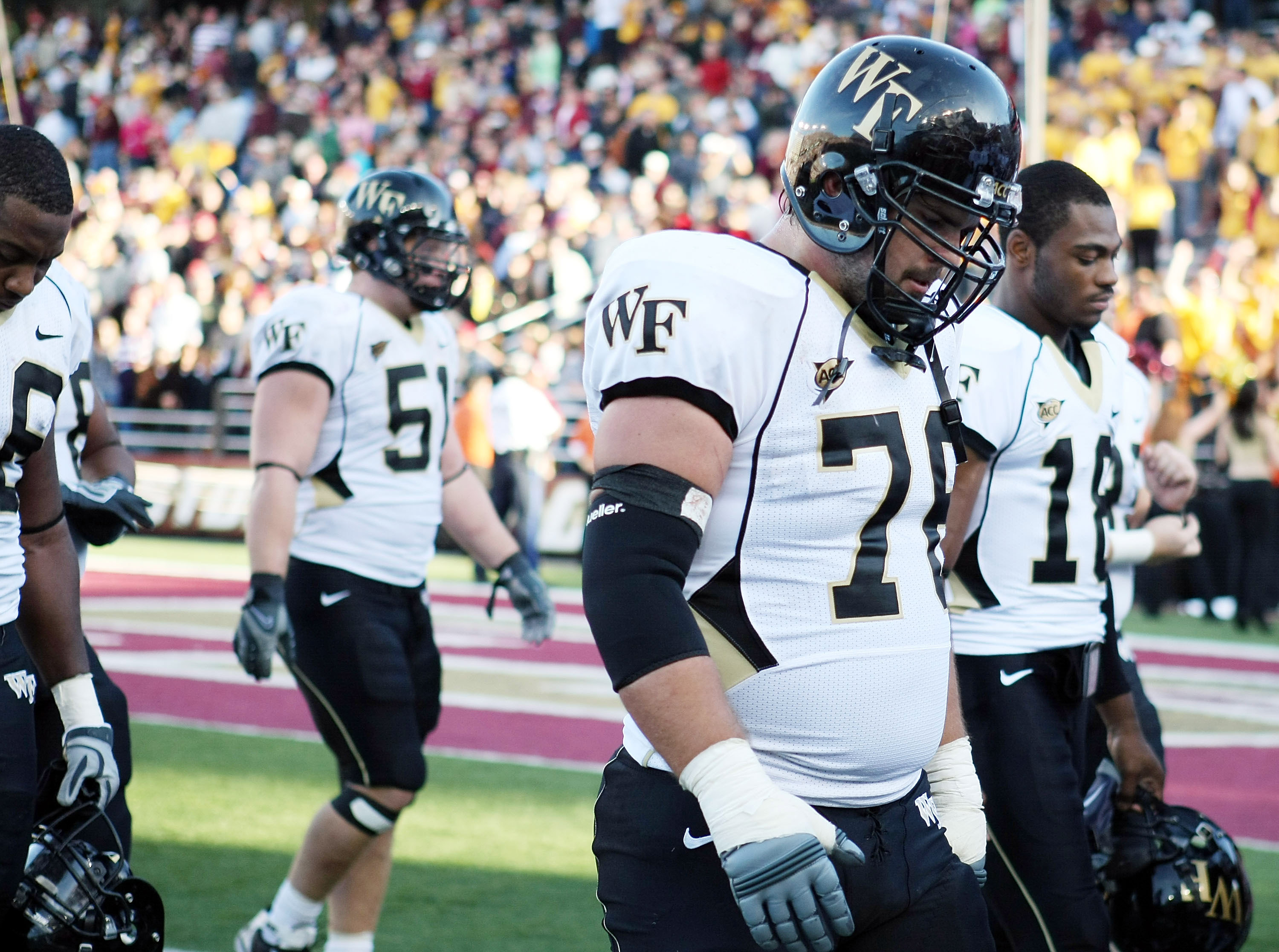CHESTNUT HILL, MA - SEPTEMBER 26:  Joe Birdsong #76, John Russell #51 and Danny Dembry #18 of the Wake Forest Demon Deacons walk off the field after the loss to the Boston College Eagles on September 26, 2009 at Alumni Stadium in Chestnut Hill, Massachuse