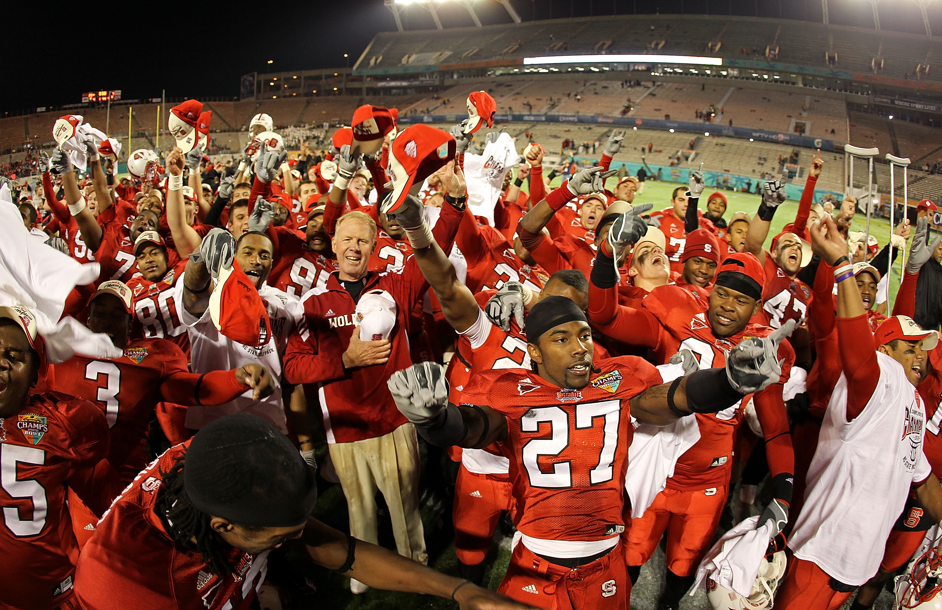 ORLANDO, FL - DECEMBER 28:  North Carolina State Wolfpack head coach Tom O'Brien celebrates after winning  the Champs Sports Bowl against the West Virginia Mountineers at Florida Citrus Bowl Stadium on December 28, 2010 in Orlando, Florida.  (Photo by Mik