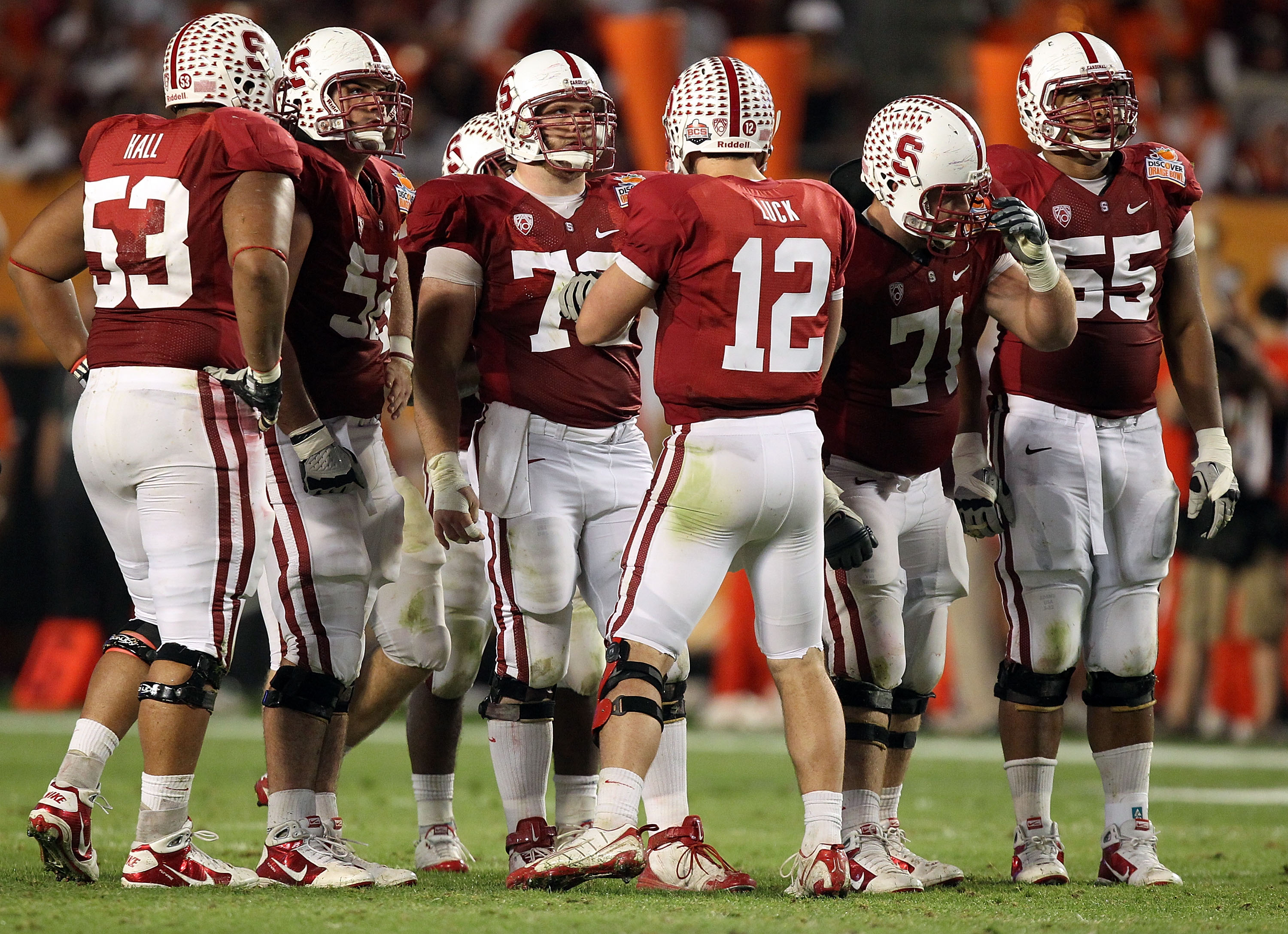 MIAMI, FL - JANUARY 03: Quarterback Andrew Luck #12 of the Stanford Cardinal calls a play in the huddle as Derek Hall #53, David DeCastro #52, Chase Beeler #72, Andrew Phillips #71 and Jonathan Martin #55 listen to the call against the Virginia Tech Hokie