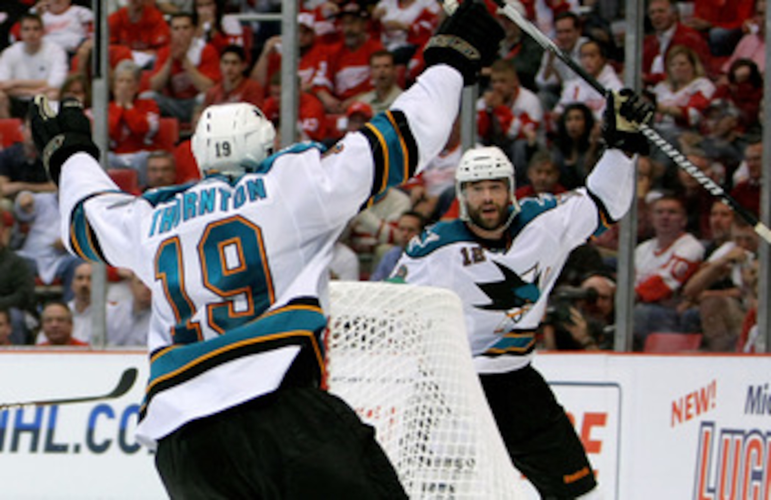 DETROIT - MAY 4:  Patrick Marleau #12 of the San Jose Sharks celebrates his overtime game-winning goal with teammate Joe Thornton #19 who assisted on the goal against the Detroit Red Wings in Game Three of the Western Conference Semifinals during the 2010