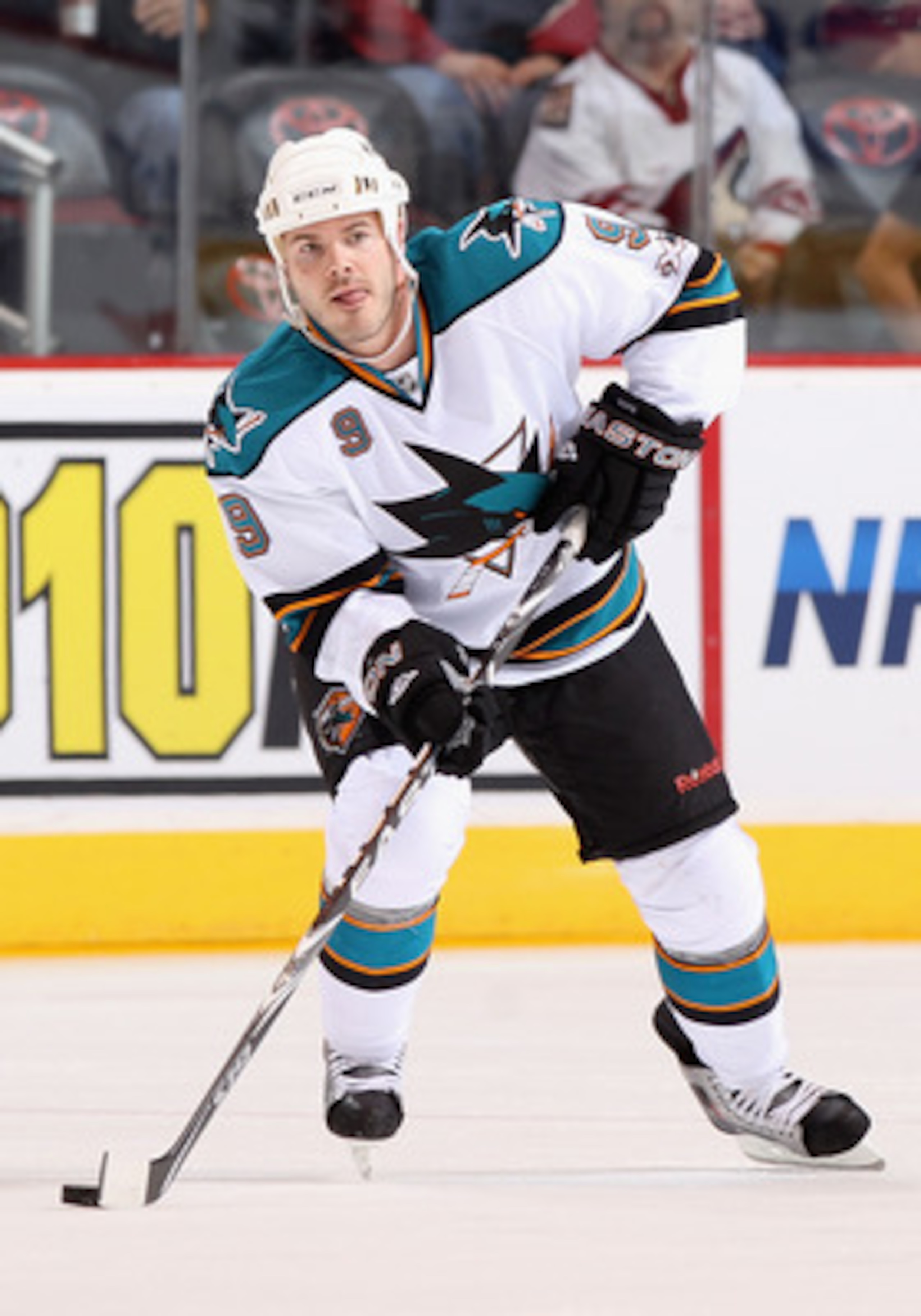 GLENDALE, AZ - MARCH 26:  Ian White #9 of the San Jose Sharks skates with the puck during the NHL game against the Phoenix Coyotes at Jobing.com Arena on March 26, 2011 in Glendale, Arizona. The Sharks defeated the Coyotes 4-1.  (Photo by Christian Peters