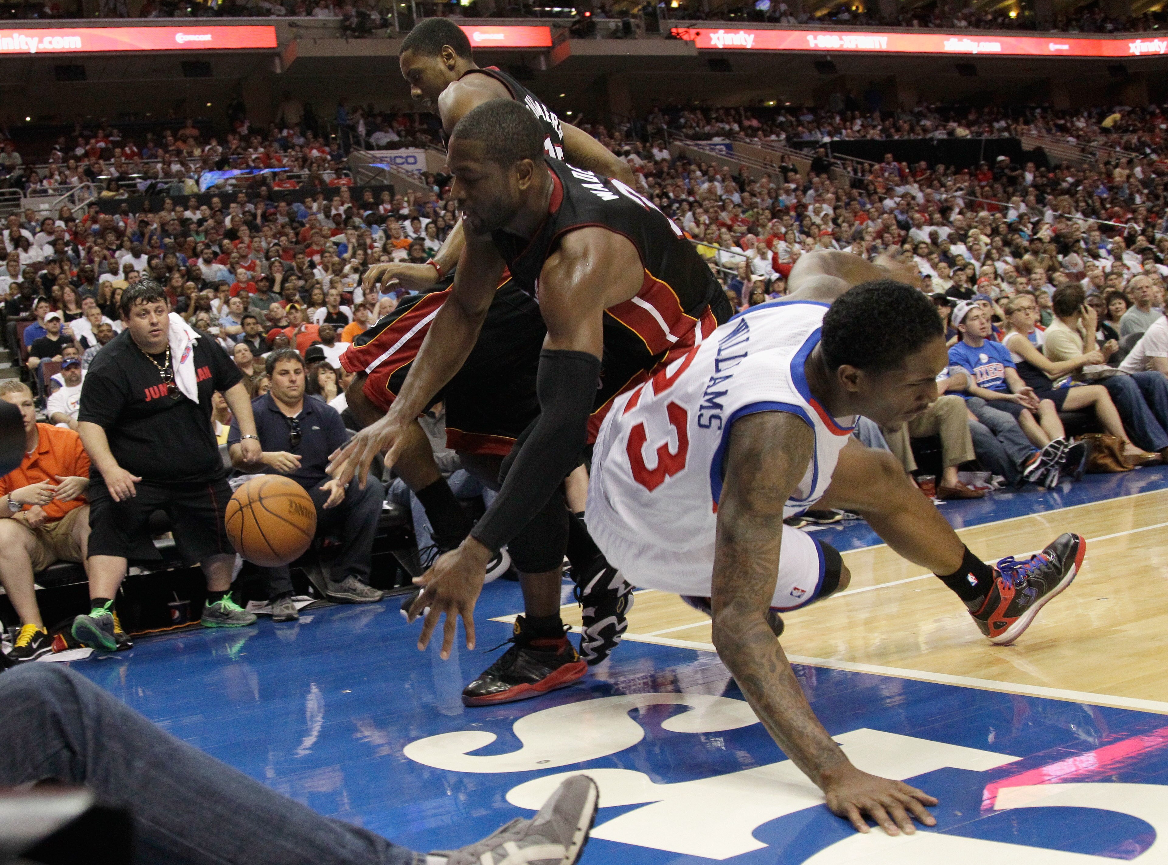PHILADELPHIA, PA - APRIL 24:  Mario Chalmers #15 (L) and Dwyane Wade #3 of the Miami Heat (C) go after a loose ball with Lou Williams #23 of the Philadelphia 76ers during the second half in Game Four of the Eastern Conference Quarterfinals in the 2011 NBA