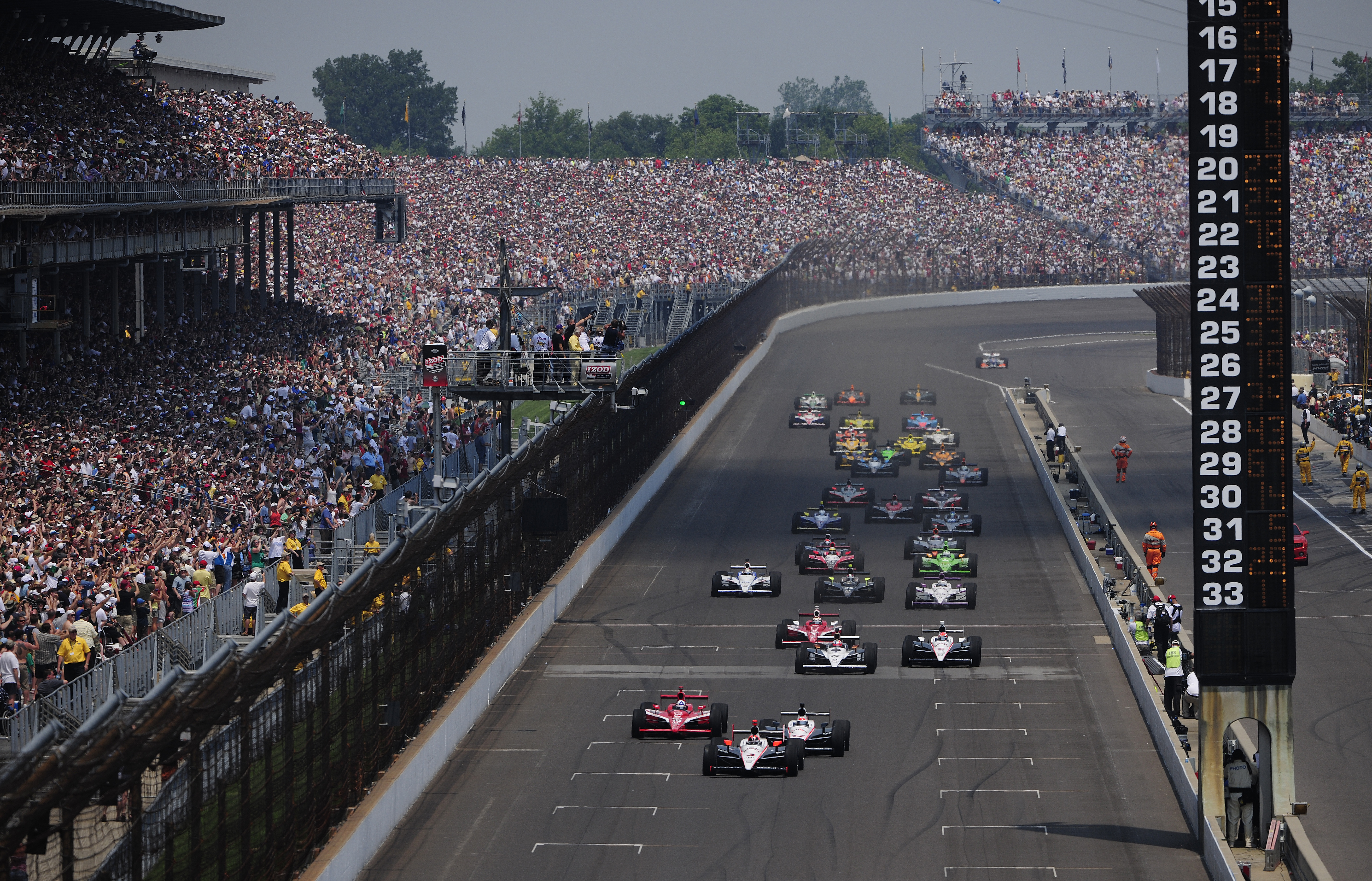 INDIANAPOLIS - MAY 30:  Helio Castroneves of Brazil, driver of the #3 Team Penske Dallara Honda, leads the field at the start of the IZOD IndyCar Series 94th running of the Indianapolis 500 at the Indianapolis Motor Speedway on May 30, 2010 in Indianapoli