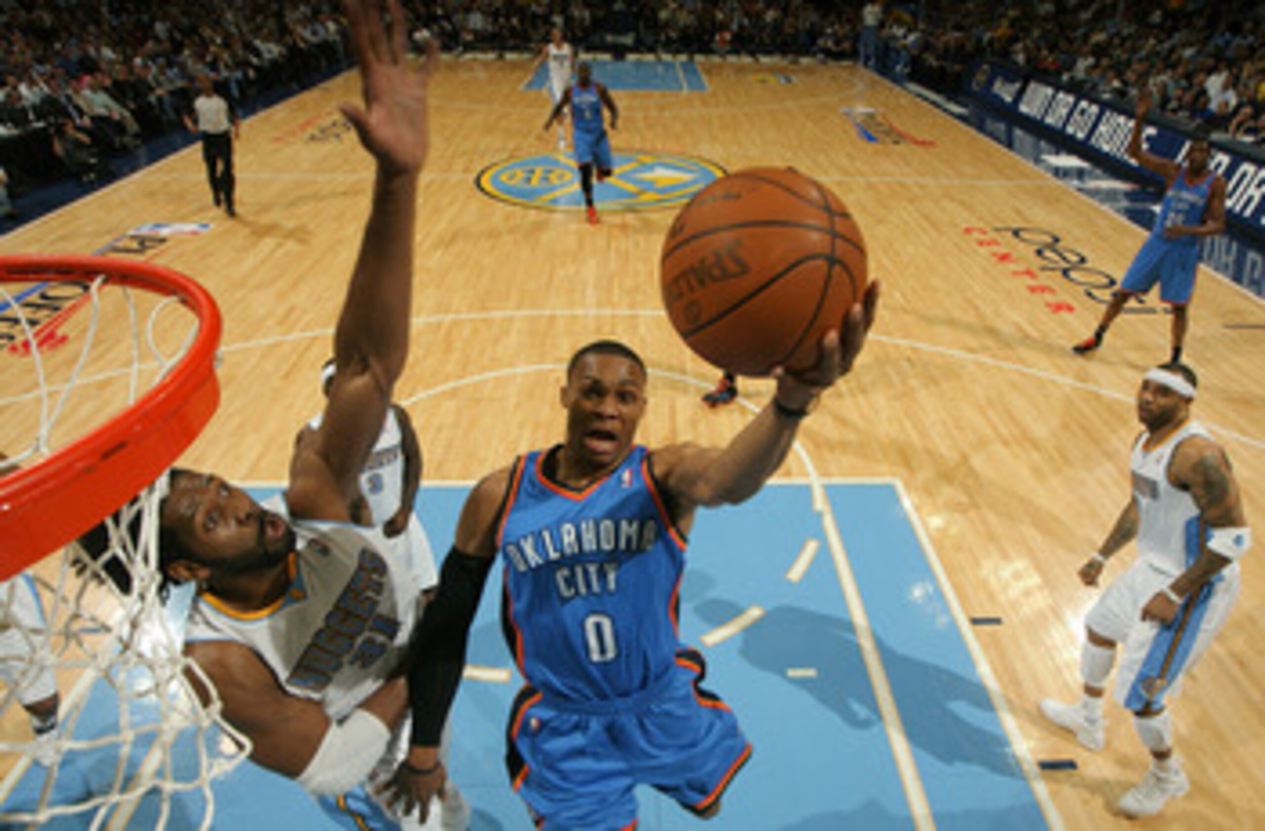DENVER, CO - APRIL 25:  Russell Westbrook #0 of the Oklahoma City Thunder goes up for a layup as Nene #31 of the Denver Nuggets contests the shot in Game Four of the Western Conference Quarterfinals in the 2011 NBA Playoffs at Pepsi Center on April 25, 20