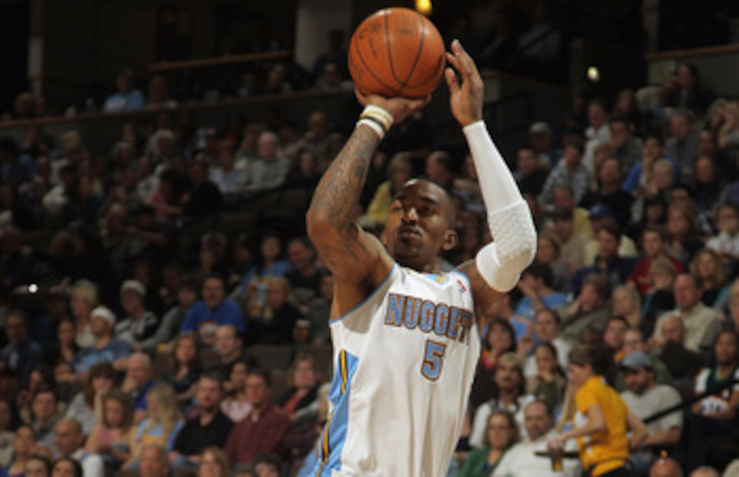 DENVER, CO - MARCH 21: J.R. Smith #5 of the Denver Nuggets takes a shot over Leandro Barbosa #20 of the Toronto Raptors at the Pepsi Center on March 21, 2011 in Denver, Colorado. The Nuggets defeated the Raptors 123-90. NOTE TO USER: User expressly ackno DENVER, CO - MARCH 21: J.R. Smith #5 of the Denver Nuggets takes a shot over Leandro Barbosa #20 of the Toronto Raptors at the Pepsi Center on March 21, 2011 in Denver, Colorado. The Nuggets defeated the Raptors 123-90. NOTE TO USER: User expressly ackno