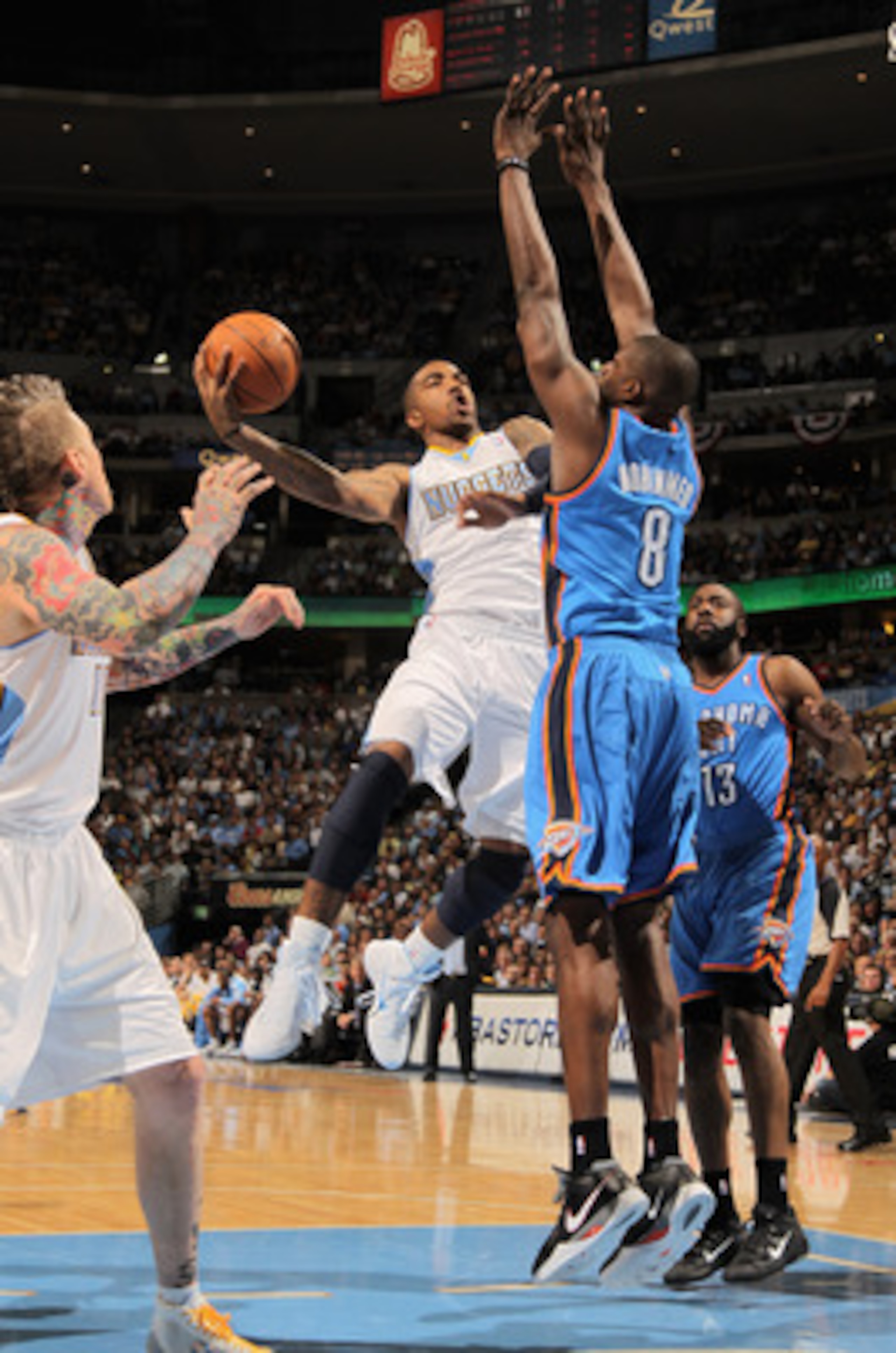 DENVER, CO - APRIL 23: J.R. Smith #5 of the Denver Nuggets puts up a shot against Nazr Mohammed #8 of the Oklahoma City Thunder in Game Three of the Western Conference Quarterfinals in the 2011 NBA Playoffs on April 23, 2011 at the Pepsi Center in Denver DENVER, CO - APRIL 23: J.R. Smith #5 of the Denver Nuggets puts up a shot against Nazr Mohammed #8 of the Oklahoma City Thunder in Game Three of the Western Conference Quarterfinals in the 2011 NBA Playoffs on April 23, 2011 at the Pepsi Center in Denver