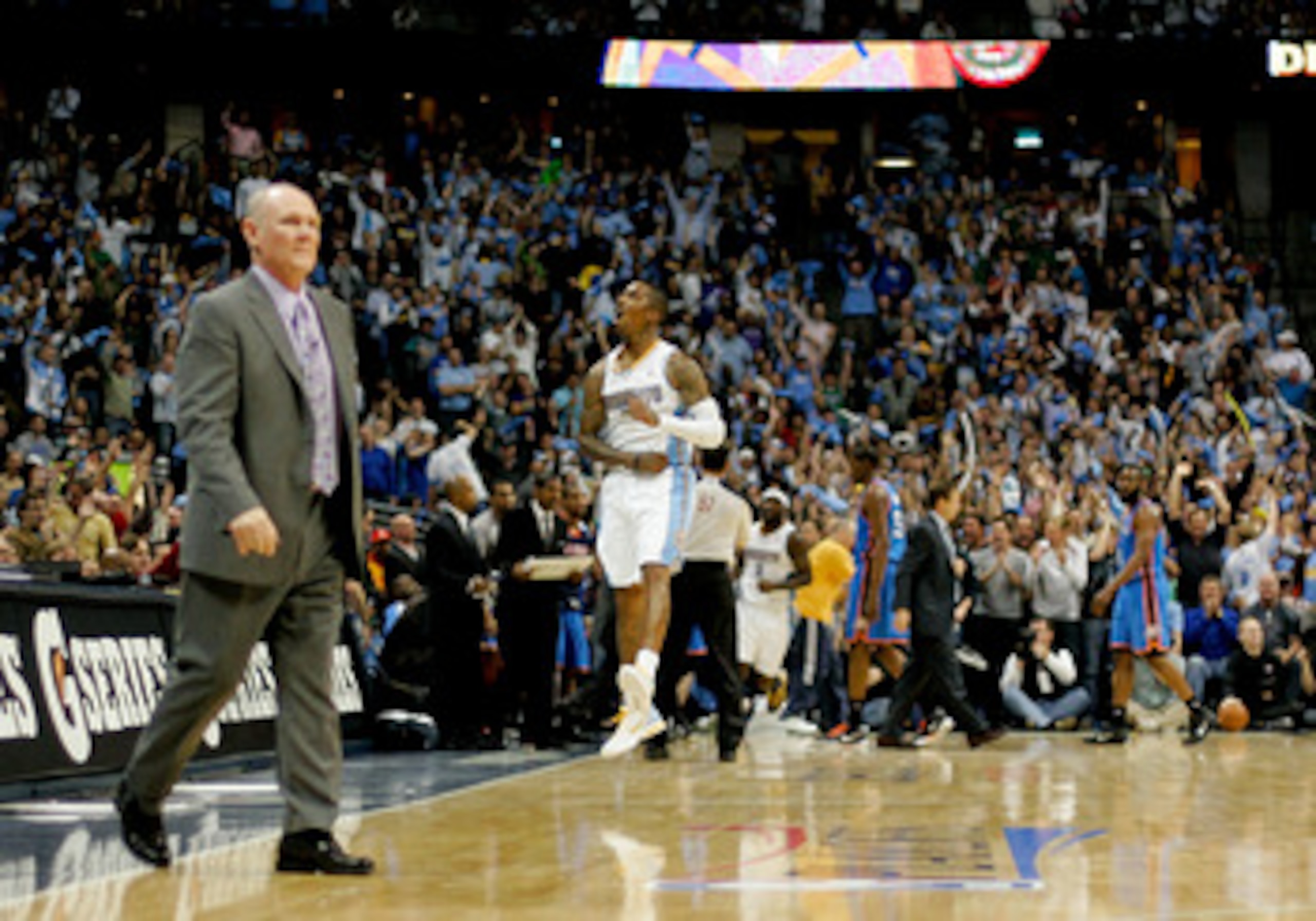 DENVER, CO - APRIL 25: J.R. Smith #5 of the Denver Nuggets celebrates a three point basket as head coach George Karl walks onto the court for a timeout against the Oklahoma City Thunder in Game Four of the Western Conference Quarterfinals in the 2011 NBA DENVER, CO - APRIL 25: J.R. Smith #5 of the Denver Nuggets celebrates a three point basket as head coach George Karl walks onto the court for a timeout against the Oklahoma City Thunder in Game Four of the Western Conference Quarterfinals in the 2011 NBA