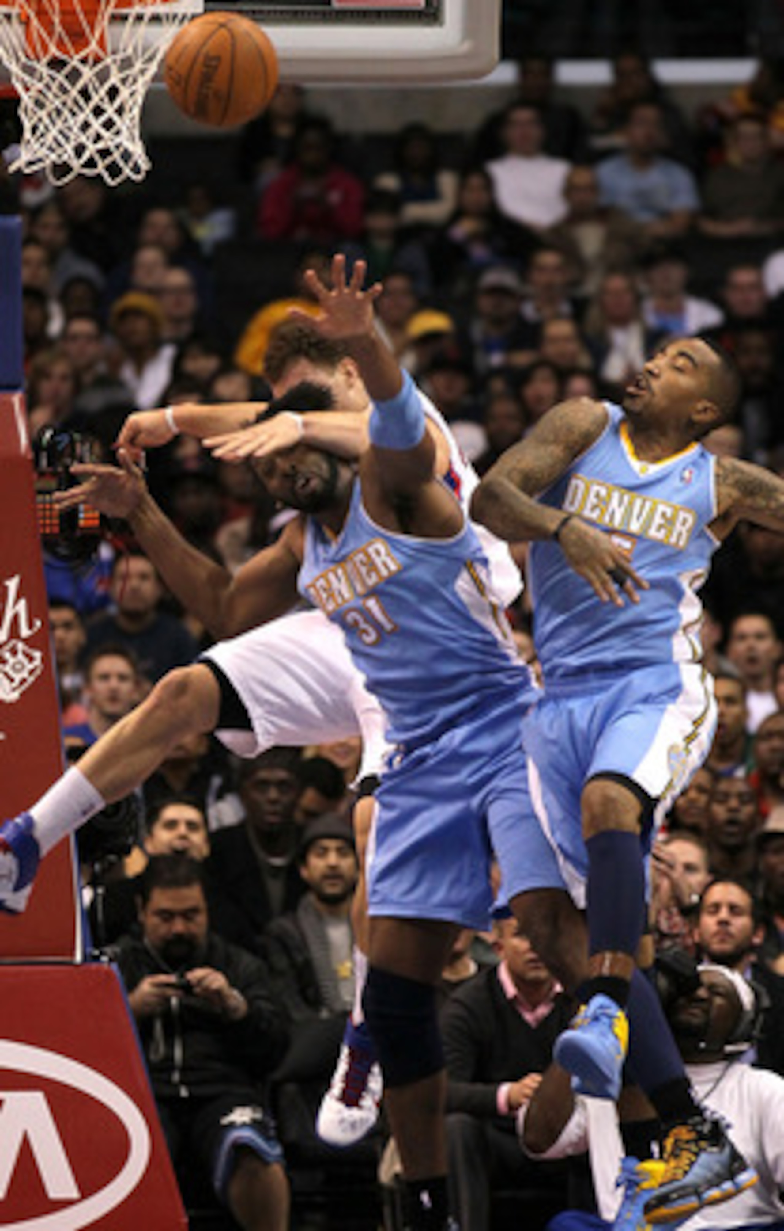 LOS ANGELES, CA - JANUARY 5: Blake Griffin #32 of the Los Angeles Clippers goes for a loose ball against Nene #31 and J.R. Smith #5 of the Denver Nuggets at Staples Center on January 5, 2011 in Los Angeles, California. The Clippers won 106-93. NOTE TO LOS ANGELES, CA - JANUARY 5: Blake Griffin #32 of the Los Angeles Clippers goes for a loose ball against Nene #31 and J.R. Smith #5 of the Denver Nuggets at Staples Center on January 5, 2011 in Los Angeles, California. The Clippers won 106-93. NOTE TO