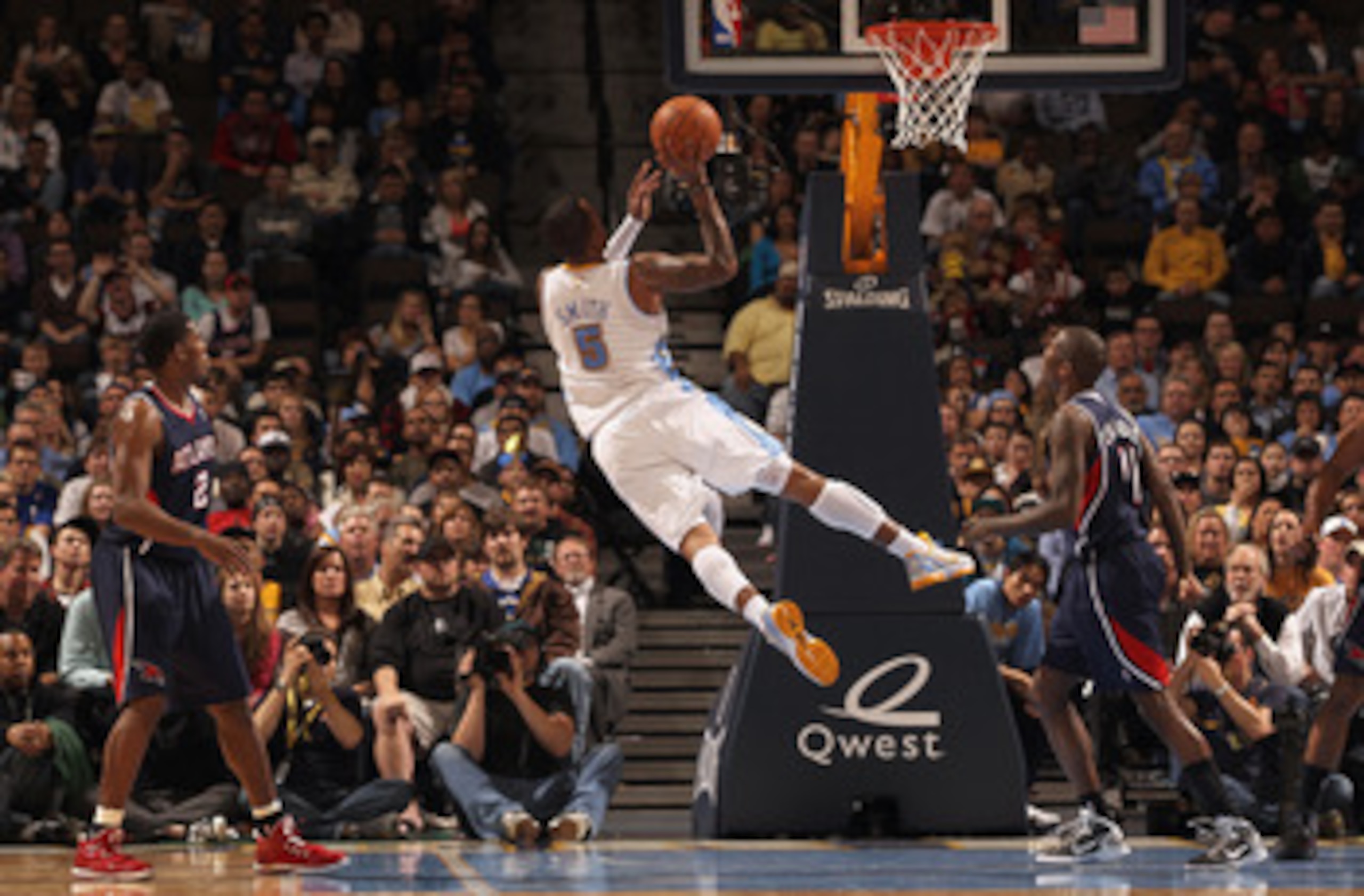 DENVER, CO - FEBRUARY 28: J.R. Smith #5 of the Denver Nuggets puts up a shot between Joe Johnson #2 and Jamal Crawford #11 of the Atlanta Hawks during NBA action at the Pepsi Center on February 28, 2011 in Denver, Colorado. The Nuggets deafeated the Hawk DENVER, CO - FEBRUARY 28: J.R. Smith #5 of the Denver Nuggets puts up a shot between Joe Johnson #2 and Jamal Crawford #11 of the Atlanta Hawks during NBA action at the Pepsi Center on February 28, 2011 in Denver, Colorado. The Nuggets deafeated the Hawk