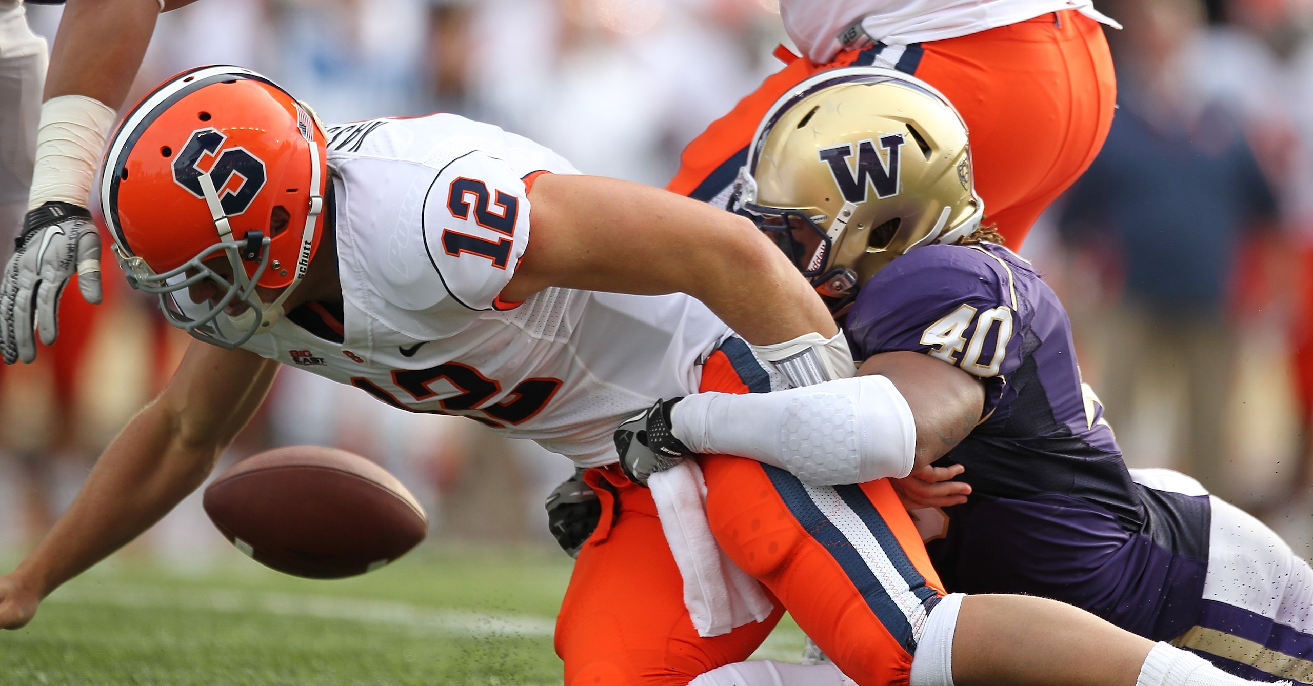 SEATTLE - SEPTEMBER 11: Quarterback Ryan Nassib #12 of the Syracuse Orange fumbles the ball against Mason Foster #40 of the Washington Huskies on September 11, 2010 at Husky Stadium in Seattle, Washington. The Huskies defeated the Orange 41-20. (Photo by SEATTLE - SEPTEMBER 11: Quarterback Ryan Nassib #12 of the Syracuse Orange fumbles the ball against Mason Foster #40 of the Washington Huskies on September 11, 2010 at Husky Stadium in Seattle, Washington. The Huskies defeated the Orange 41-20. (Photo by