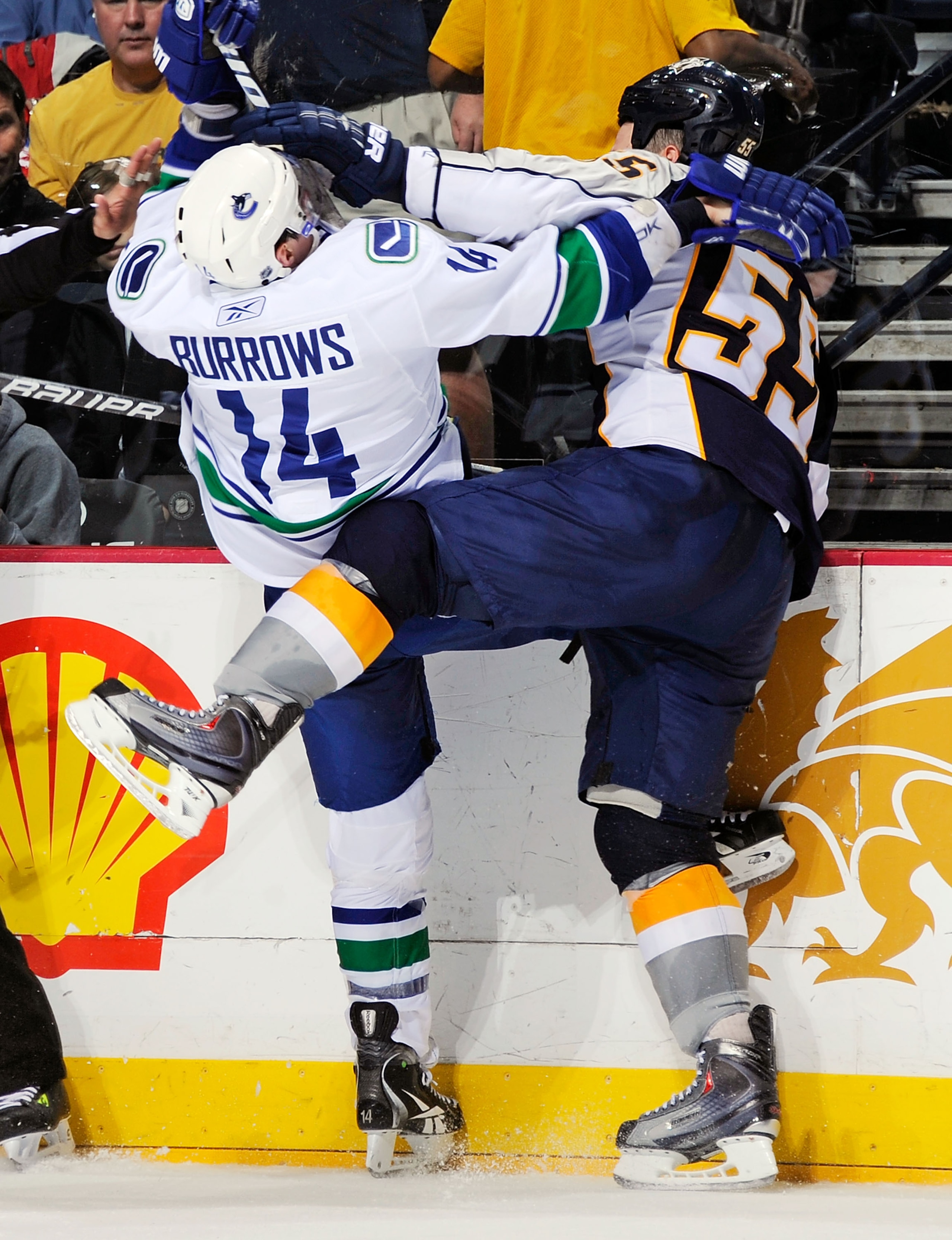 NASHVILLE, TN - MARCH 29:  Alexandre Burrows #14 of the Vancouver Canucks collides with Shane O'Brien #55 of the Nashville Predators on March 29, 2011 at the Bridgestone Arena in Nashville, Tennessee.  (Photo by Frederick Breedon/Getty Images)
