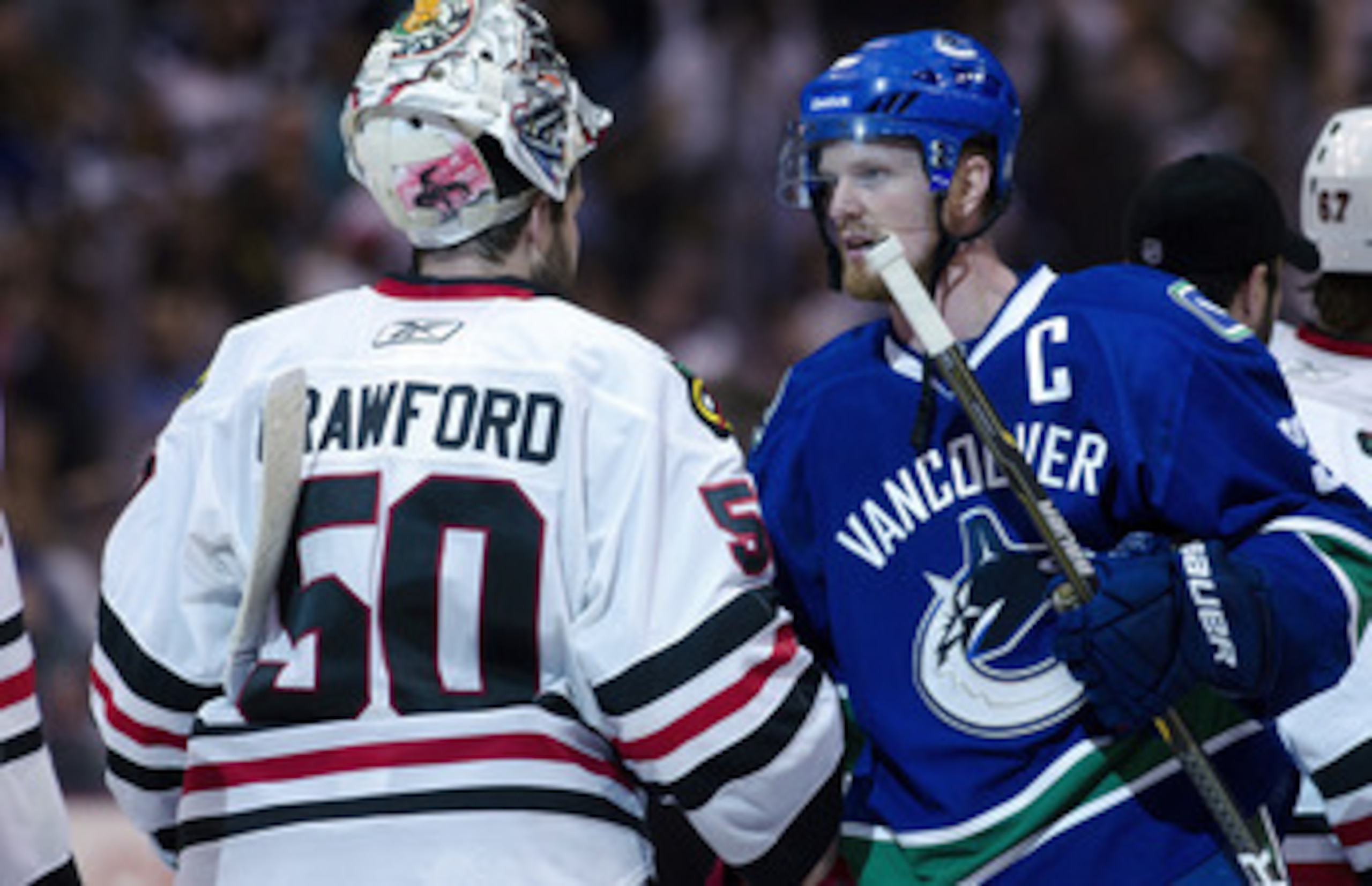 VANCOUVER, CANADA - APRIL 26: Henrik Sedin #33 (R) of the Vancouver Canucks and goalie Corey Crawford #50 of the Chicago Blackhawks shake hands after the Canucks defeated the Blackhawks 2-1 in overtime of Game Seven of the Western Conference Quarterfinals