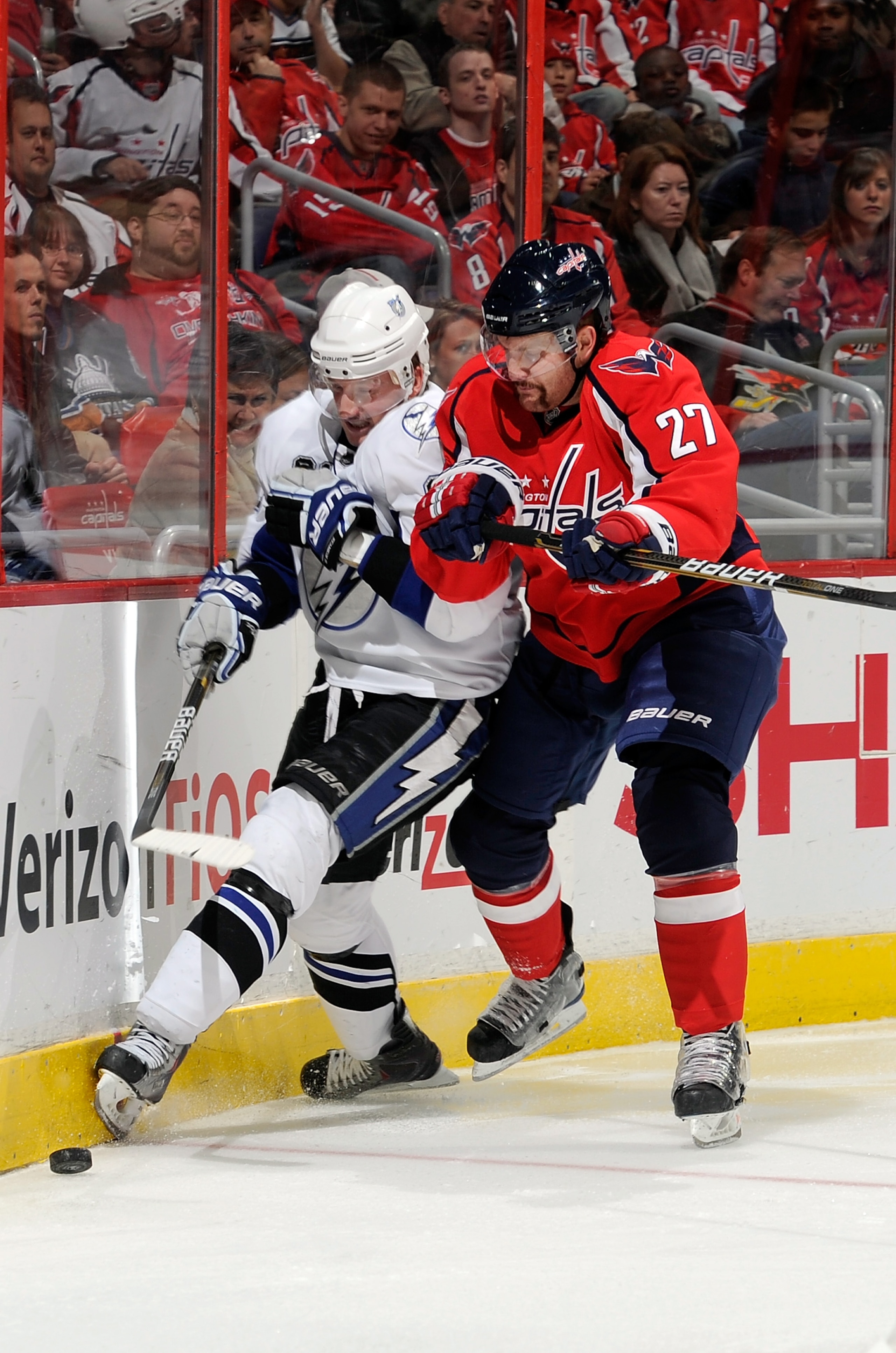 WASHINGTON - NOVEMBER 26:  Steven Stamkos #91 of the Tampa Bay Lightning is checked by Karl Alzner #27 of the Washington Capitals at the Verizon Center on November 26, 2010 in Washington, DC.  (Photo by Greg Fiume/Getty Images)