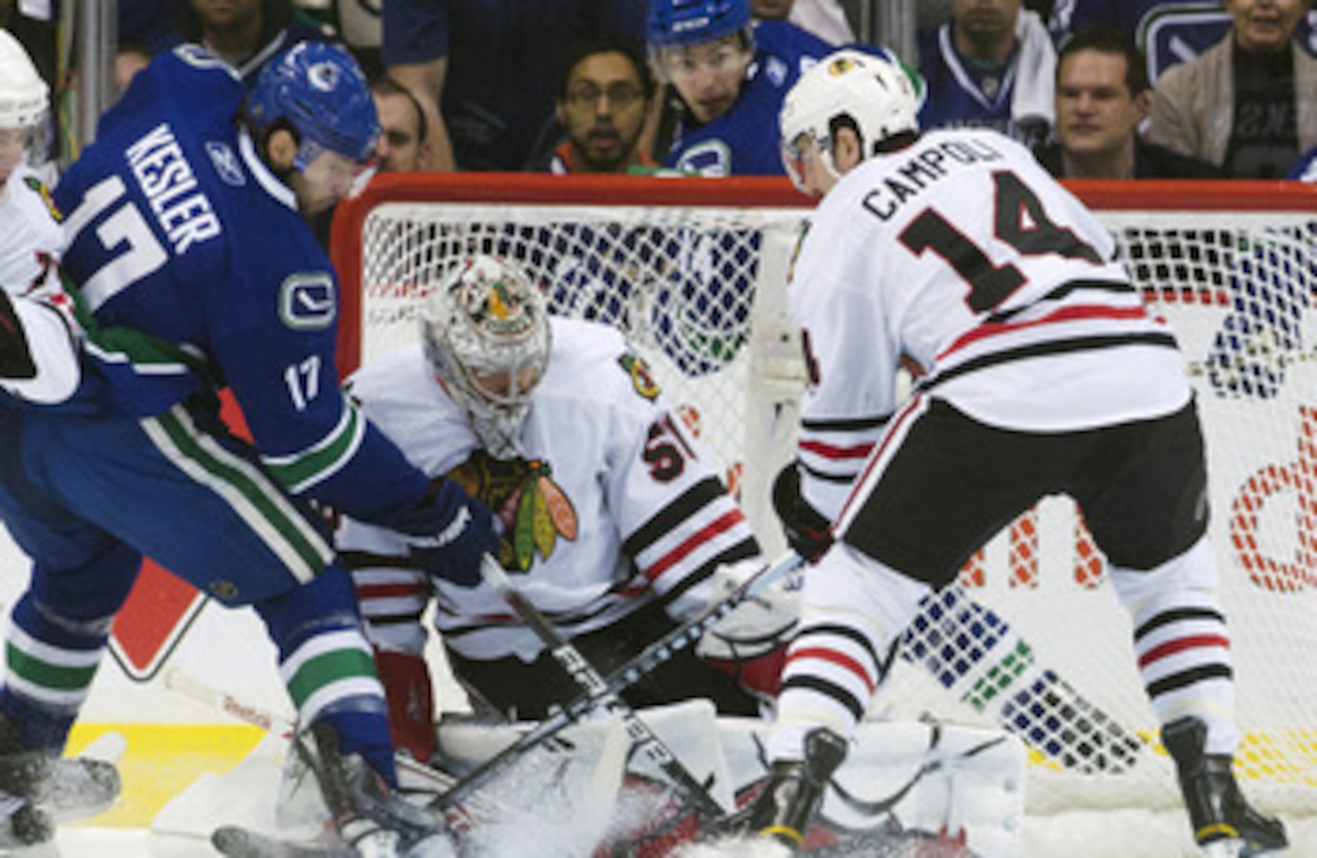 VANCOUVER, CANADA - APRIL 26: Ryan Kesler #17 of the Vancouver Canucks tips the puck towards goalie Corey Crawford #50 of the Chicago Blackhawks while being watched by Chris Campoli #14 of the Chicago Blackhawks during the first period in Game Seven of th