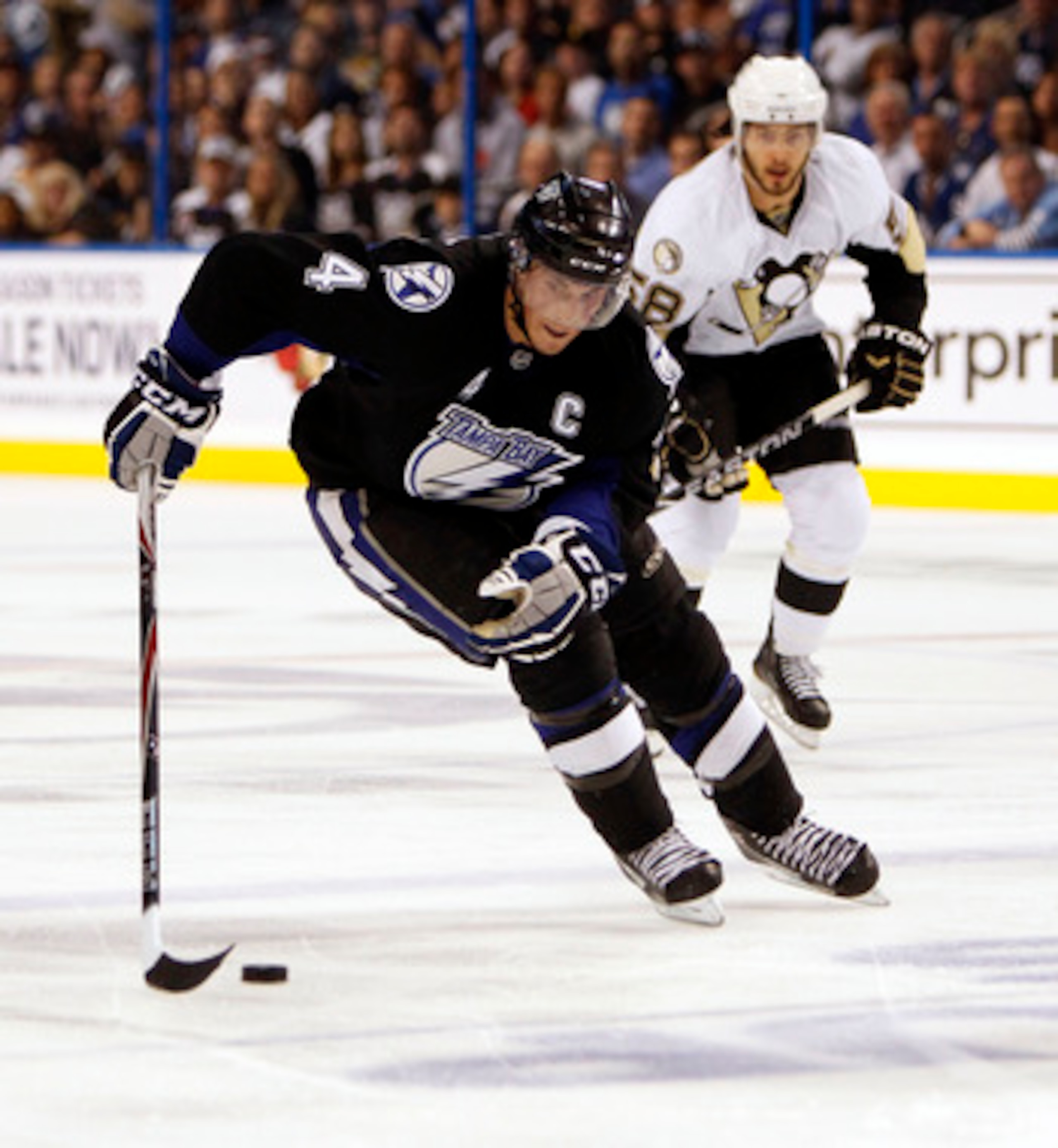 TAMPA, FL - APRIL 18: Vincent Lecavalier #4 of the Tampa Bay Lightning skates with the puck against the Pittsburgh Penguins in Game Three of the Eastern Conference Quarterfinals during the 2011 NHL Stanley Cup Playoffs at the St. Pete Times Forum on April
