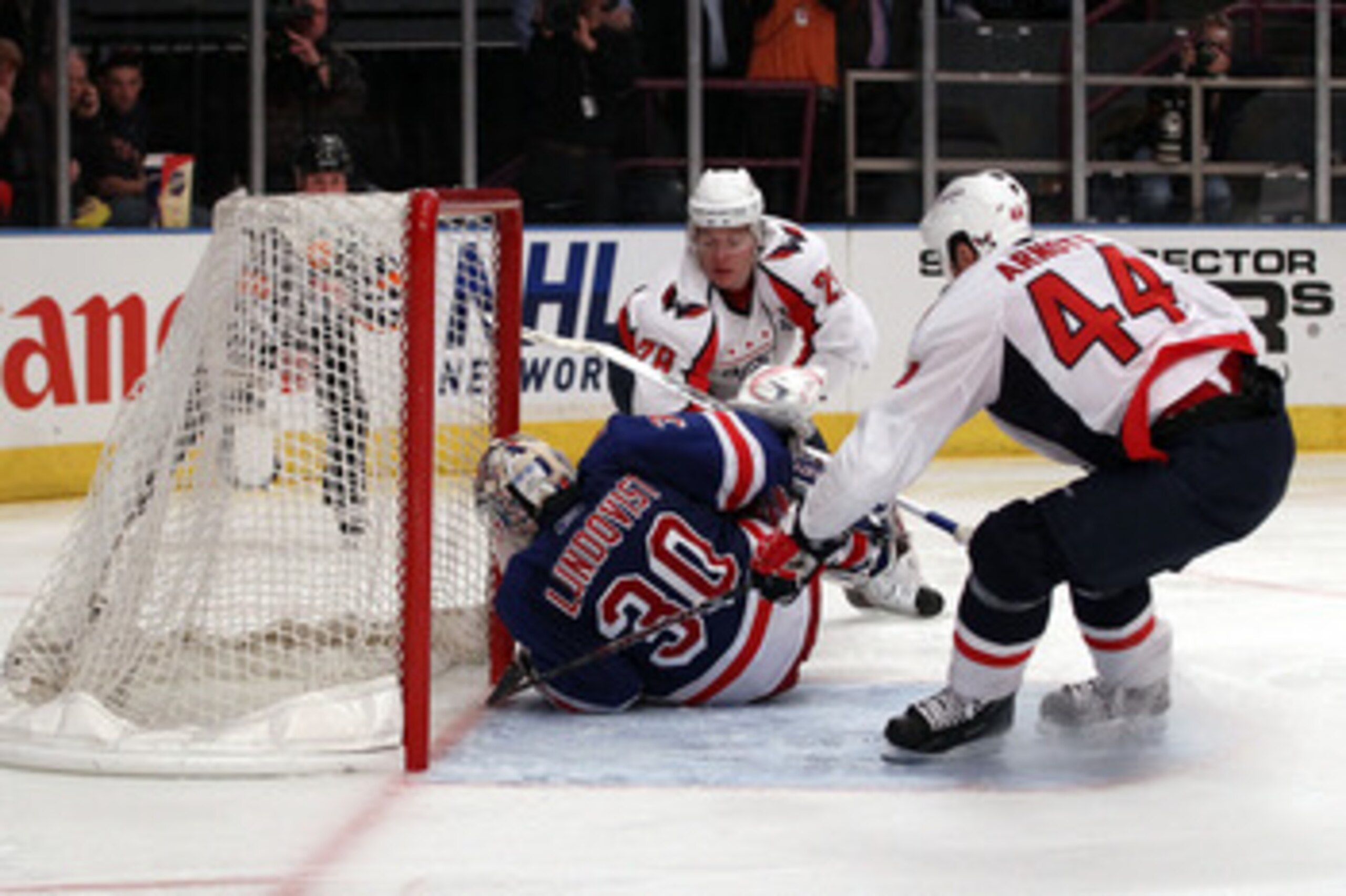 NEW YORK, NY - APRIL 20:  Alexander Semin #28 of the Washington Capitals scores a goal in the third period against goalie Henrik Lundqvist #30 of the New York Rangers in Game Four of the Eastern Conference Quarterfinals during the 2011 NHL Stanley Cup Pla