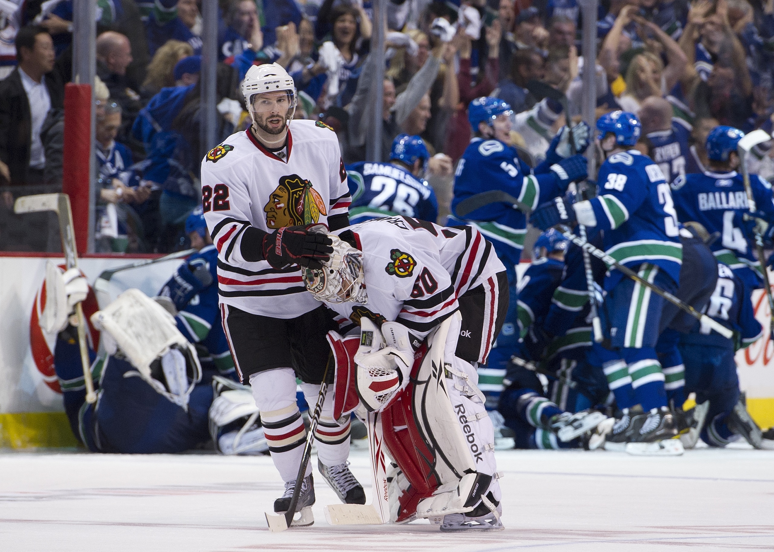 VANCOUVER, CANADA - APRIL 26: Troy Brouwer #22 consoles goalie Corey Crawford #50 of the Chicago Blackhawks after losing 2-1 in overtime to the Vancouver Canucks in Game Seven of the Western Conference Quarterfinals during the 2011 NHL Stanley Cup Playoff