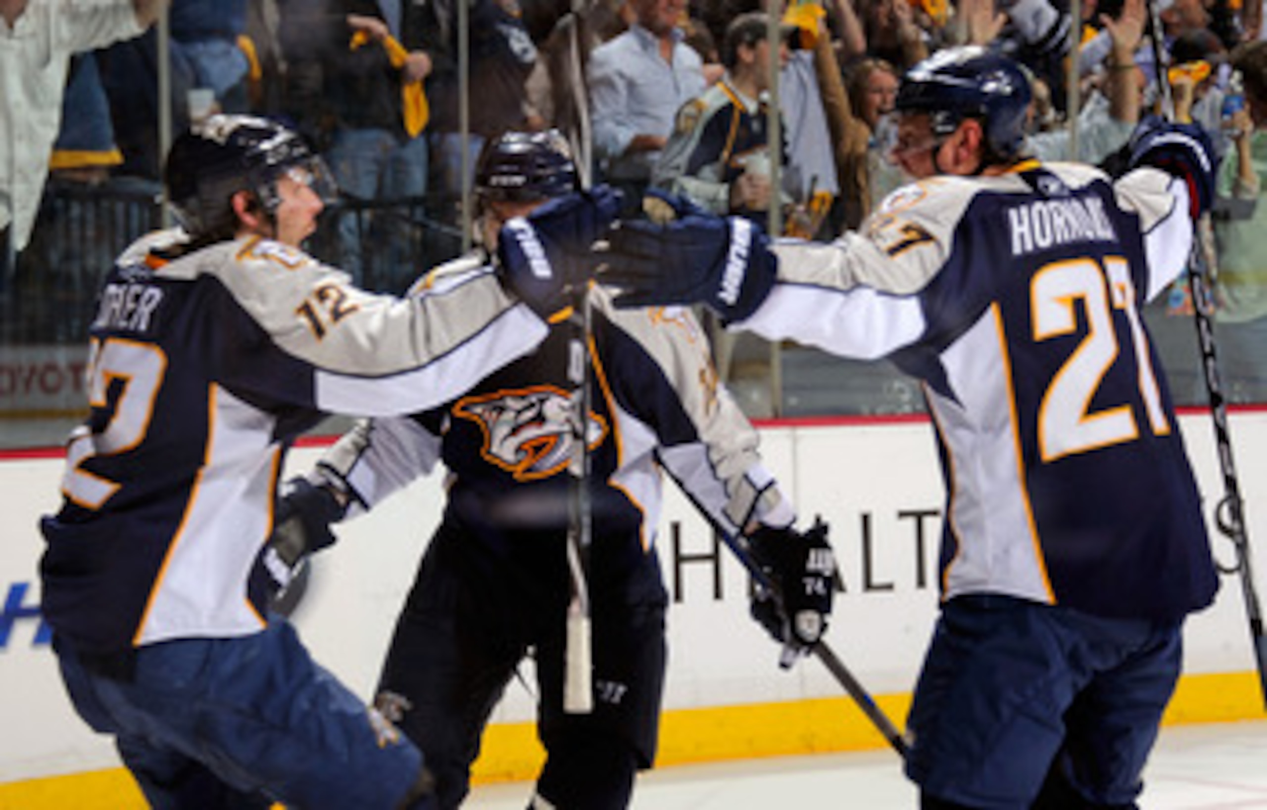 NASHVILLE, TN - APRIL 17:  Mike Fisher #12, Sergei Kostitsyn #74, and Patric Hornqvist #27 of the Nashville Predators celebrate the go ahead goal against the Anaheim Ducks in Game Three of the Western Conference Quarterfinals during the 2011 NHL Stanley C