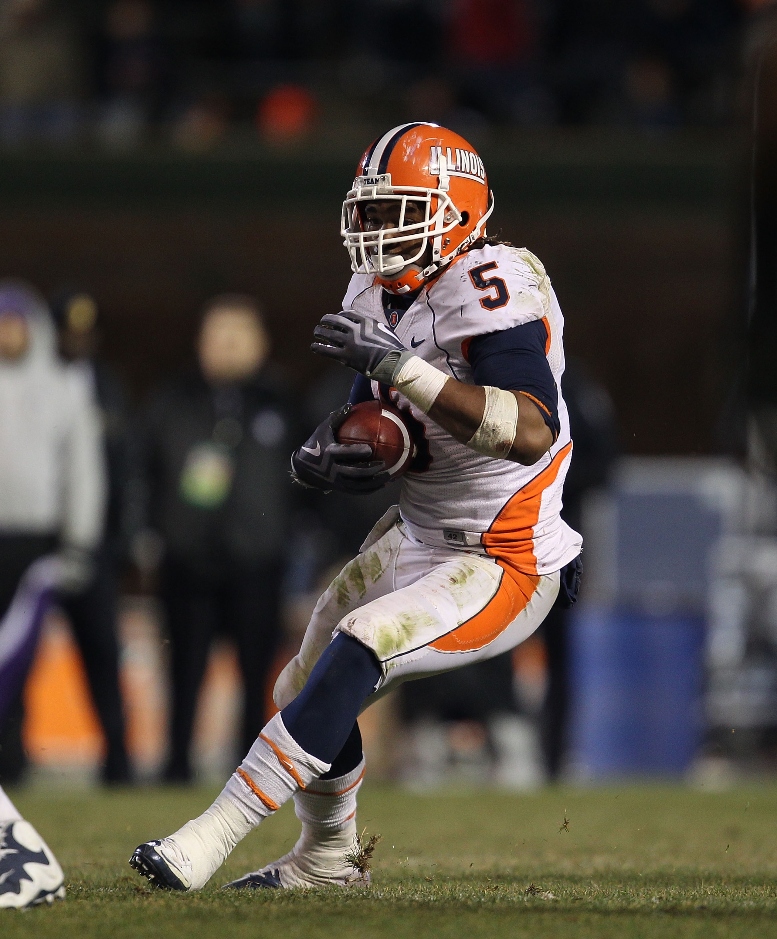 CHICAGO, IL - NOVEMBER 20: Mikel Leshoure #5 of the Illinois Fighting Illini runs against the Northwestern Wildcats closes in during a game played at Wrigley Field on November 20, 2010 in Chicago, Illinois. Illinois defeated Northwestern 48-27. (Photo by 