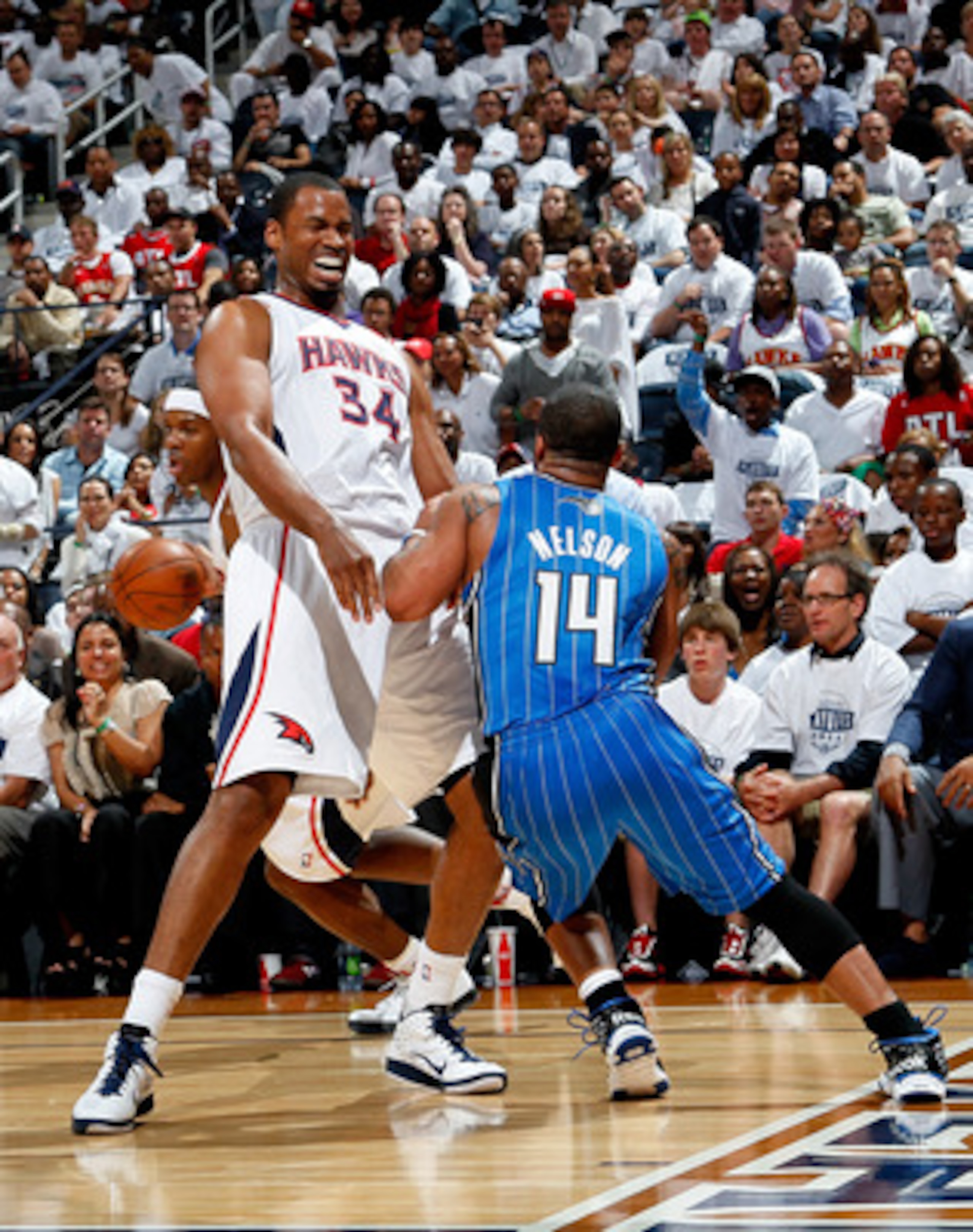 ATLANTA, GA - APRIL 22:  Jason Collins #34 of the Atlanta Hawks draws a foul from Jameer Nelson #14 of the Orlando Magic during Game Three of the Eastern Conference Quarterfinals in the 2011 NBA Playoffs at Philips Arena on April 22, 2011 in Atlanta, Geor