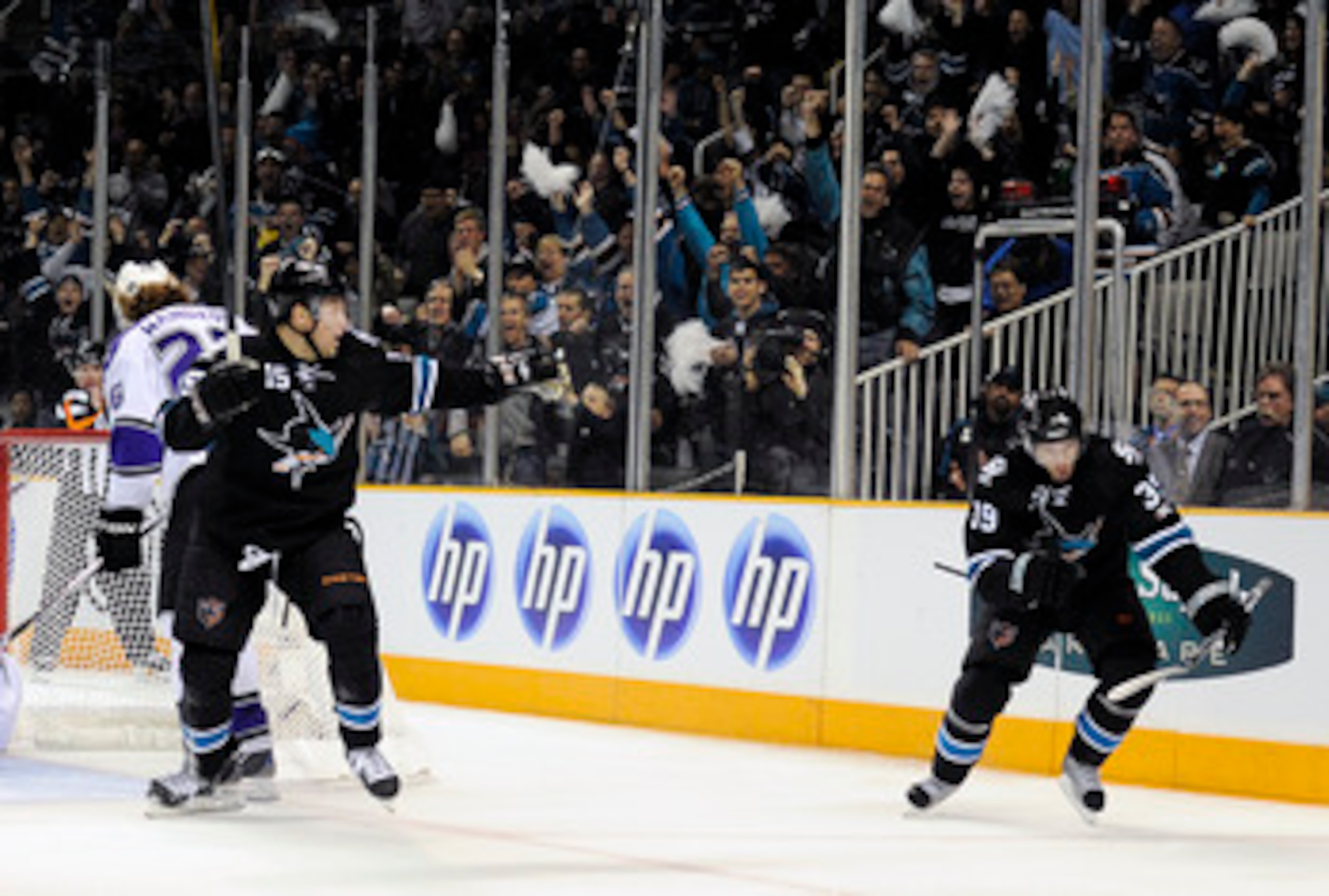 SAN JOSE, CA - APRIL 14: Logan Couture #39 and Dany Heatley #15 of the San Jose Sharks celebrates after Couture scores a goal against the Los Angeles Kings in Game One of the Western Conference Quarterfinals  during the 2011 NHL Stanley Cup Playoffs at th
