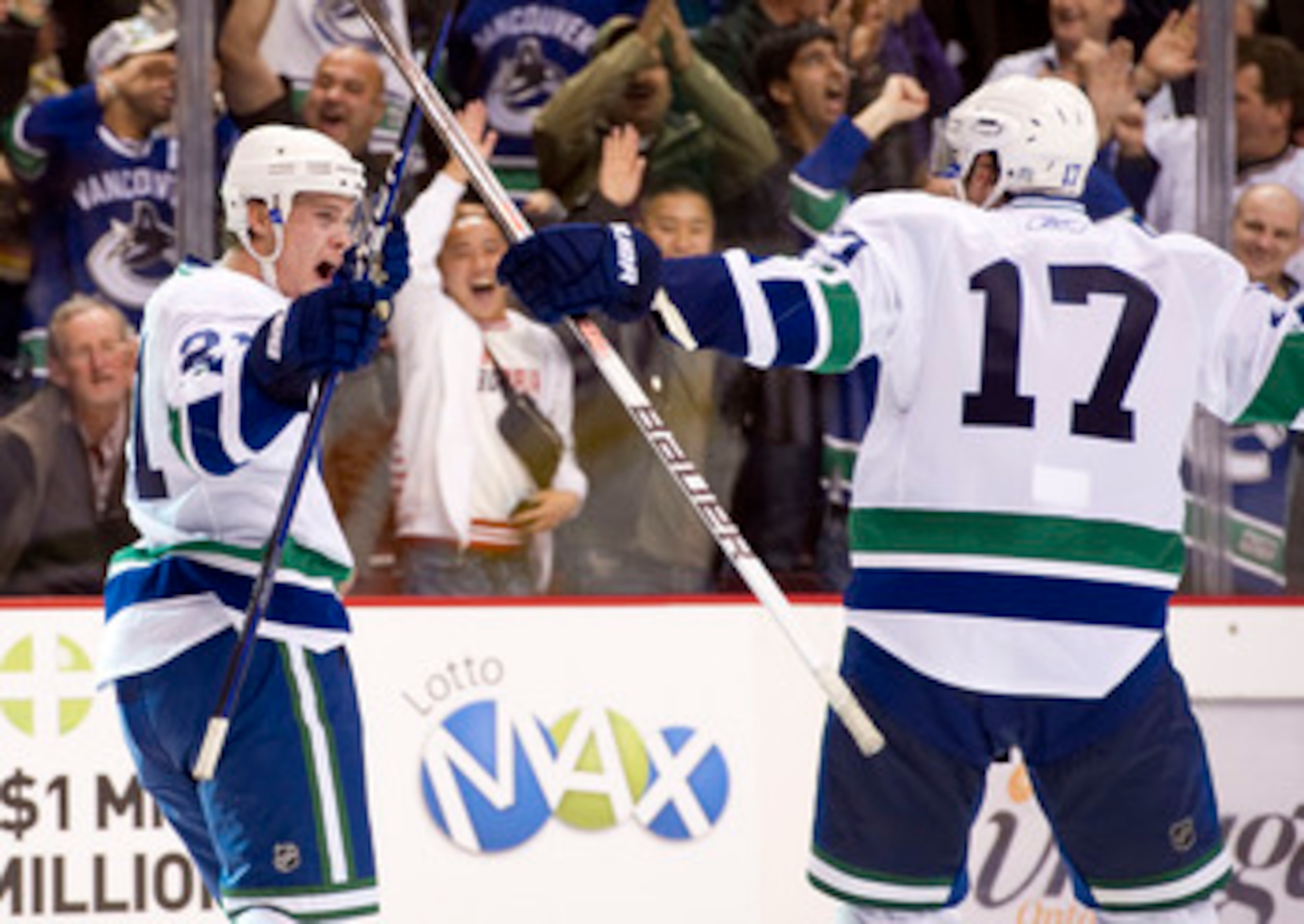 VANCOUVER, CANADA - OCTOBER 26: Mason Raymond #21 of the Vancouver Canucks celebrates with Ryan Kesler #17 after scoring against the Colorado Avalanche in overtime to win the game during NHL action on October 26, 2010 at Rogers Arena in Vancouver, British