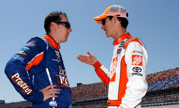 TALLADEGA, AL - APRIL 17:  Kyle Busch, driver of the #18 M&M's Pretzel Toyota, talks with Joey Logano, driver of the #20 The Home Depot Toyota, on the grid prior to the NASCAR Sprint Cup Series Aaron's 499 at Talladega Superspeedway on April 17, 2011 in T