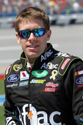 TALLADEGA, AL - APRIL 17:  Carl Edwards, driver of the #99 Aflac Ford, stands on the grid prior to the start of the NASCAR Sprint Cup Series Aaron's 499 at Talladega Superspeedway on April 17, 2011 in Talladega, Alabama.  (Photo by Jerry Markland/Getty Im