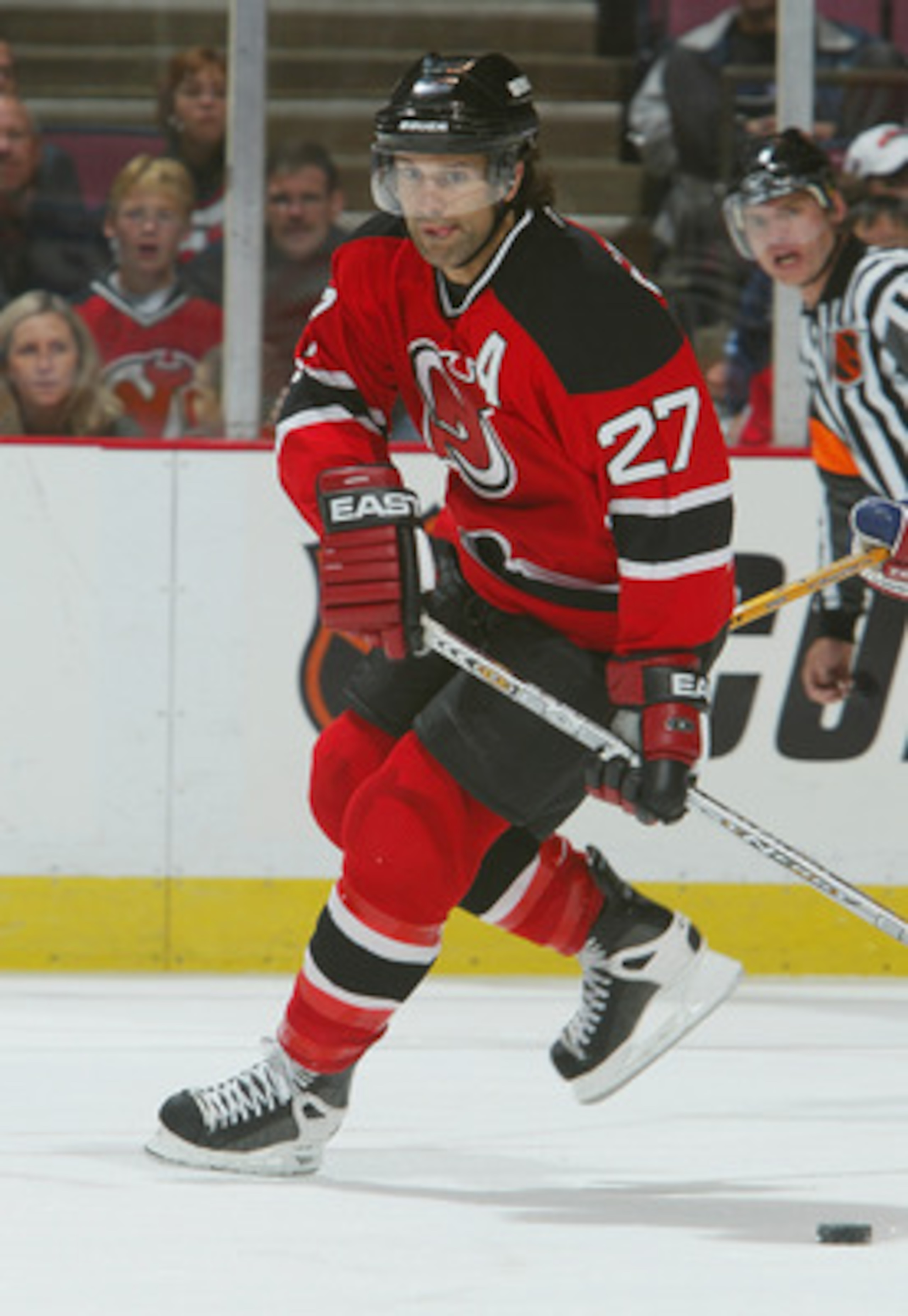 EAST RUTHERFORD, NJ - OCTOBER 3:  Defenseman Scott Niedermayer #27 of the New Jersey Devils skates with the puck against the New York Rangers during the preseason NHL game on October 3, 2003 at Continental Airlines Arena in East Rutherford, New Jersey. Th