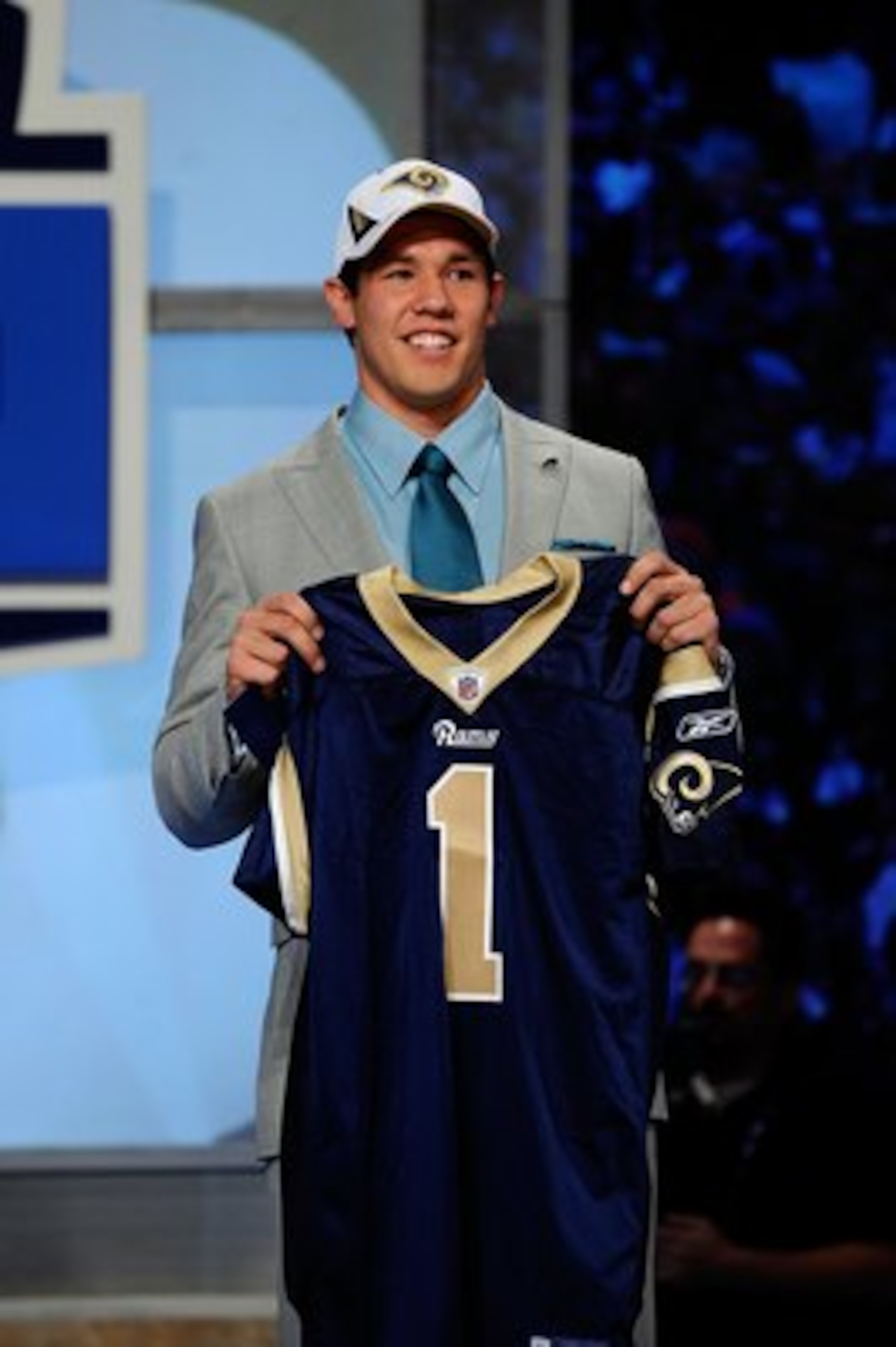 NEW YORK - APRIL 22:  Quarterback Sam Bradford from the Oklahoma Sooners holds up a St. Louis Rams jersey after the Rams selected Bradford numer 1 overall during the first round of the 2010 NFL Draft at Radio City Music Hall on April 22, 2010 in New York 