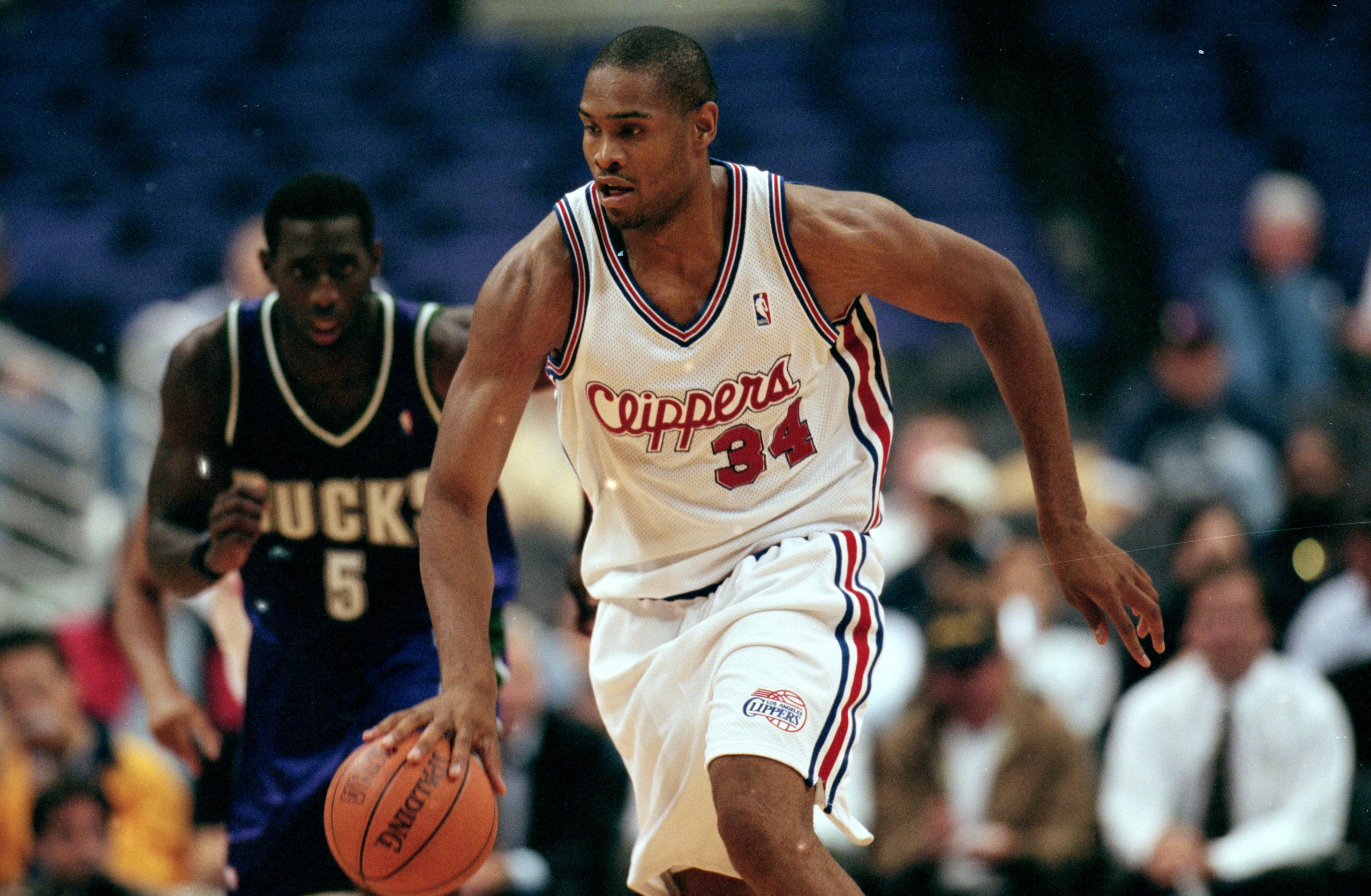 27 Oct 1999: Michael Olowokandi #34 of the Los Angeles Clippers dribbles the ball during a game against the Milwaukee Bucks at the Staples Center in Los Angeles, California. The Bucks defeated the Clippers 109-96.   Mandatory Credit: Tom Hauck  /Allsport